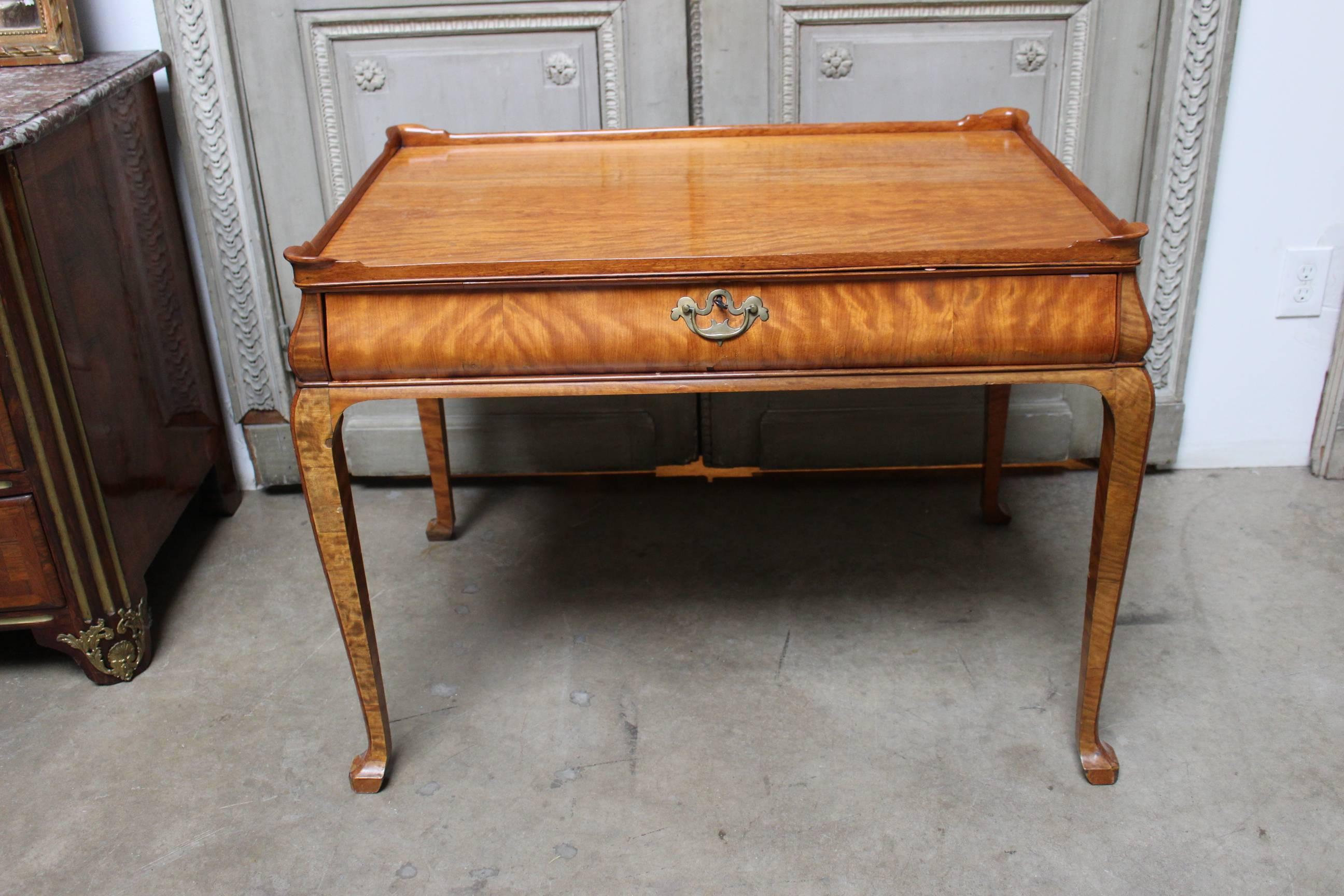 A Dutch satinwood tea table in the Queen Anne Style.