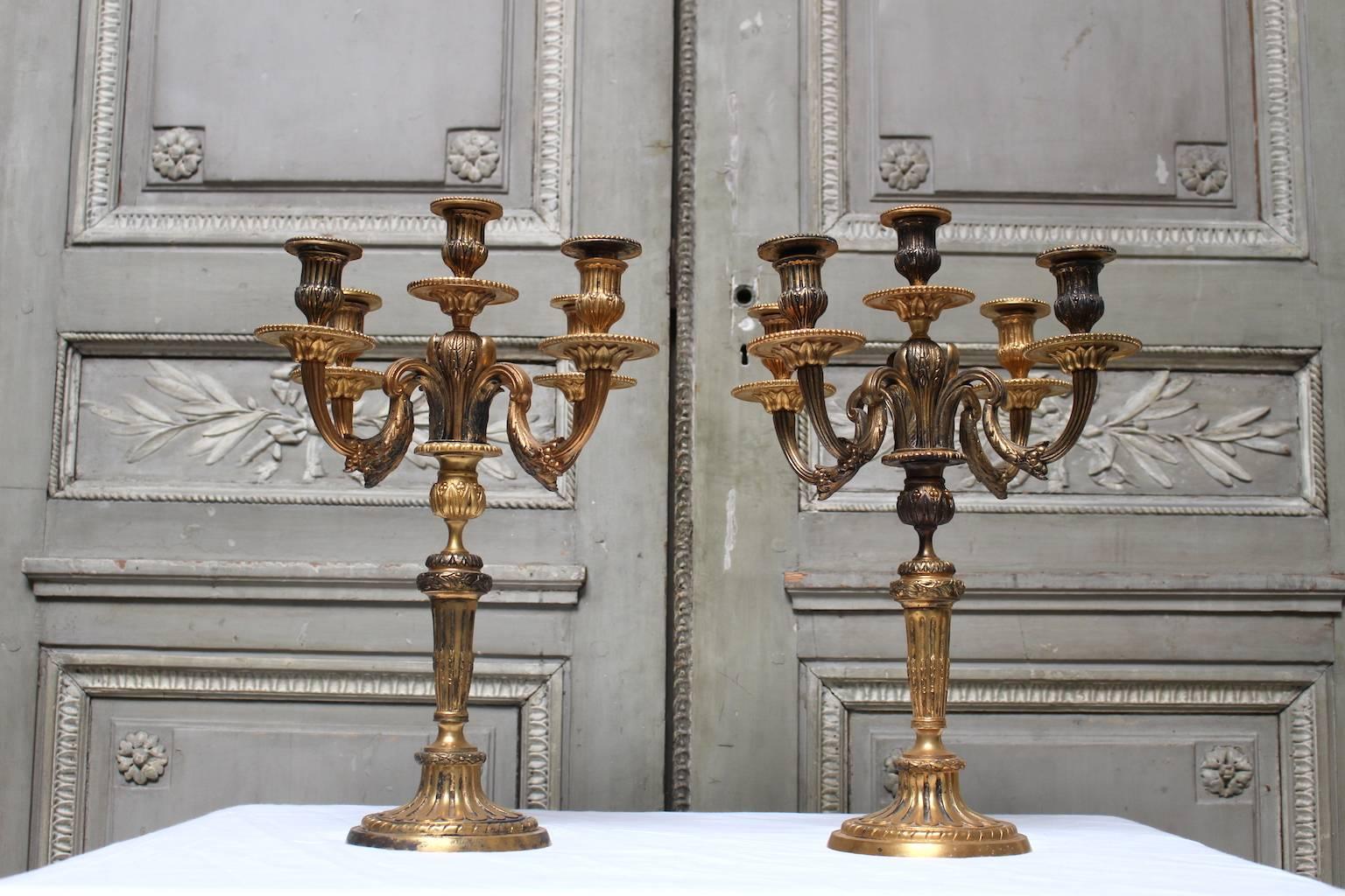 A pair of French Louis XVI style bronze candelabra.
