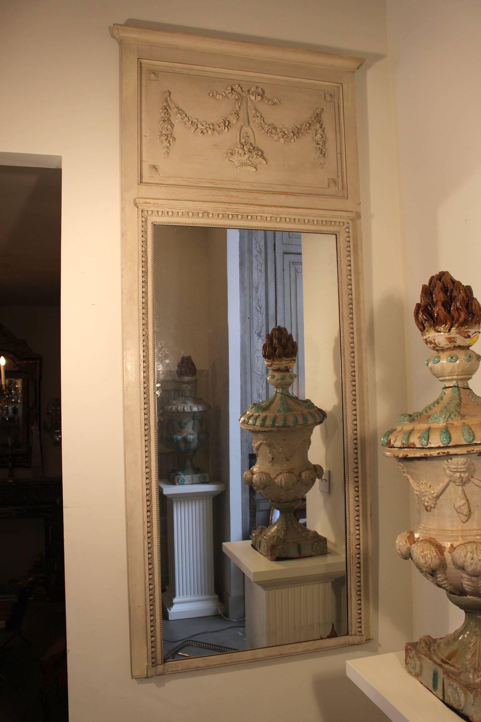 A French Louis XVI style trumeau mirror with a painted finish.
