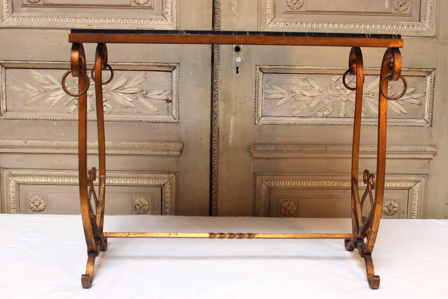 A French gilded iron table with marble top.