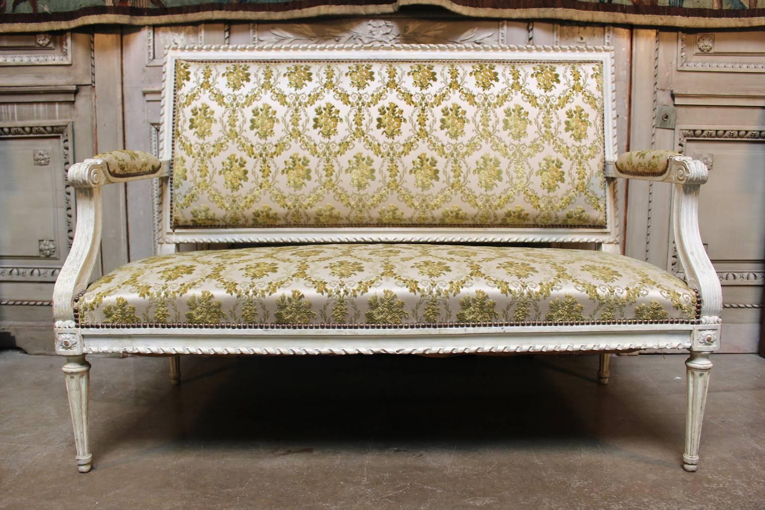 A French Louis XVI settee with a painted finish.