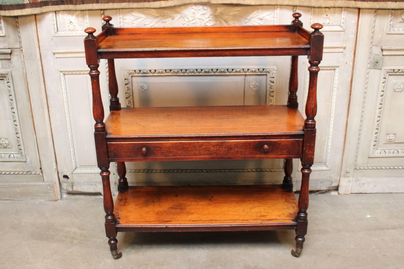 A small scale English Victorian three-tiered trolley with a drawer in mahogany