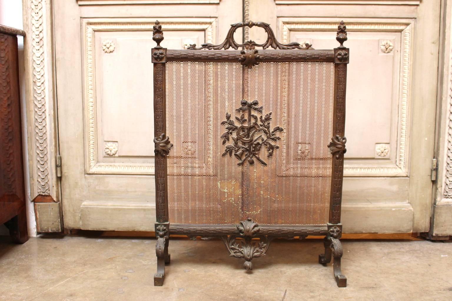 A French Louis XVI style bronze firescreen with lyre design.