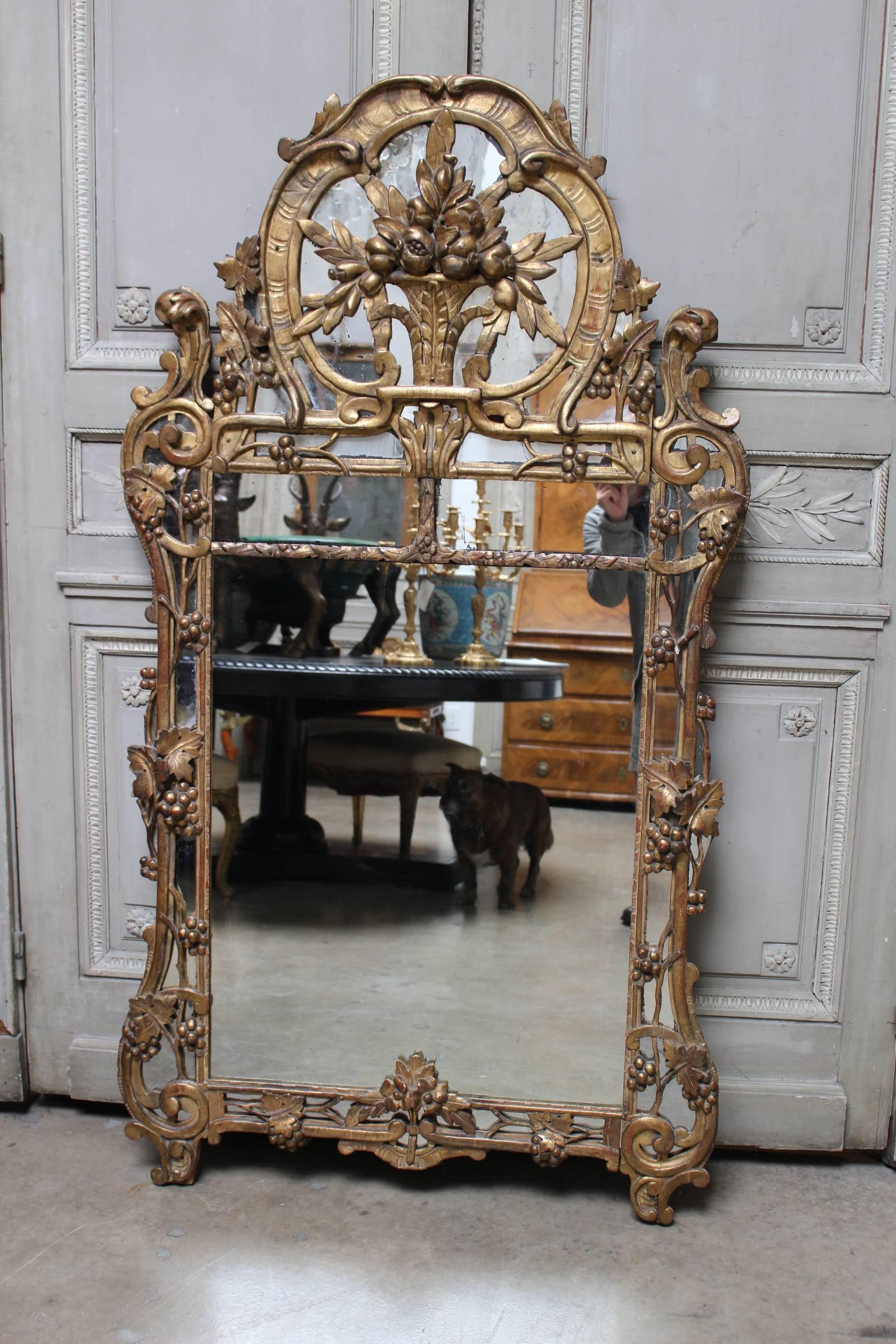 A large French Regence gilded plaster and wood mirror.