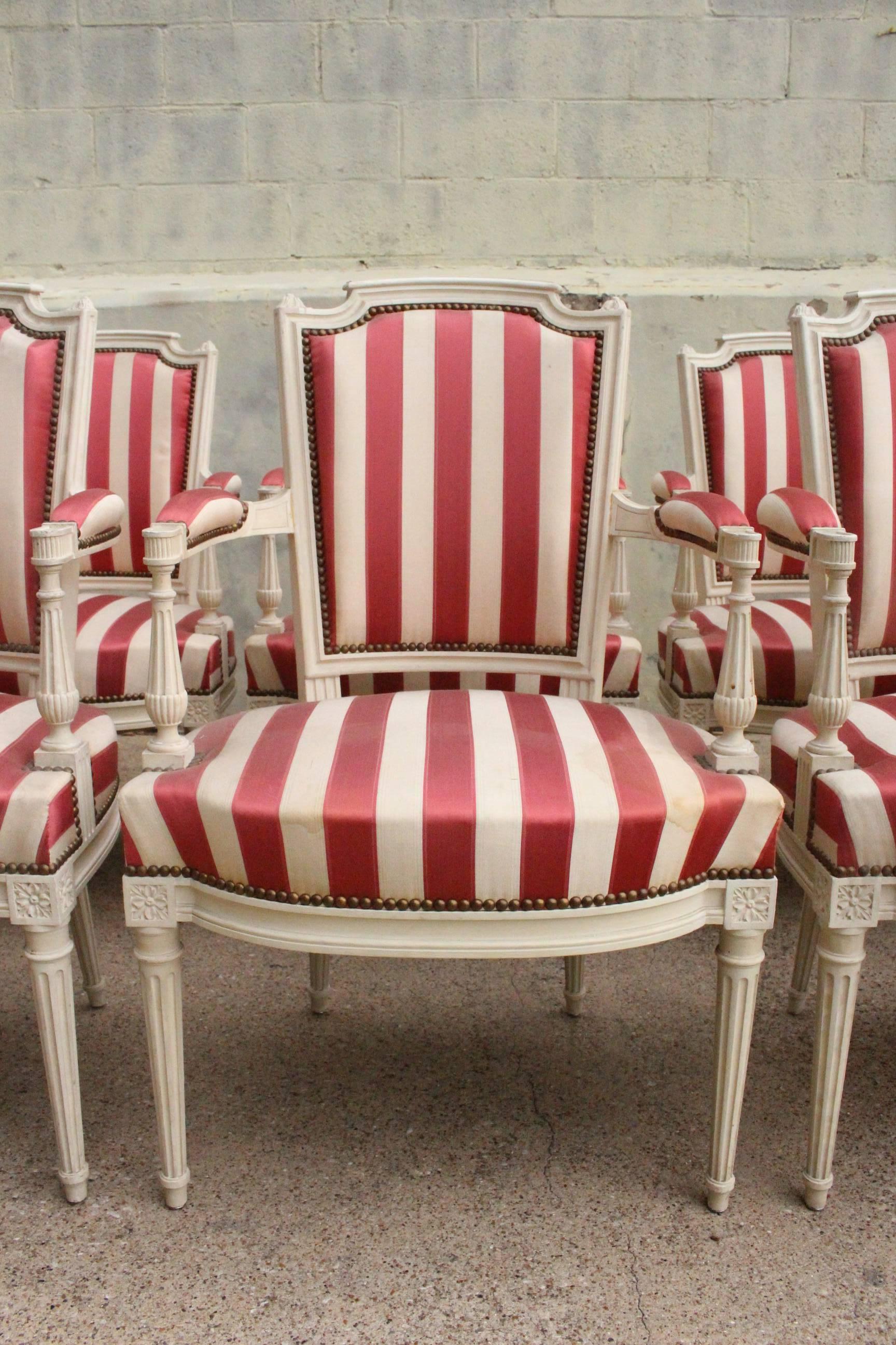 A suite of ten French Louis XVI style painted dining, armchairs. These armchairs are sold for frames only, the fabric is old.