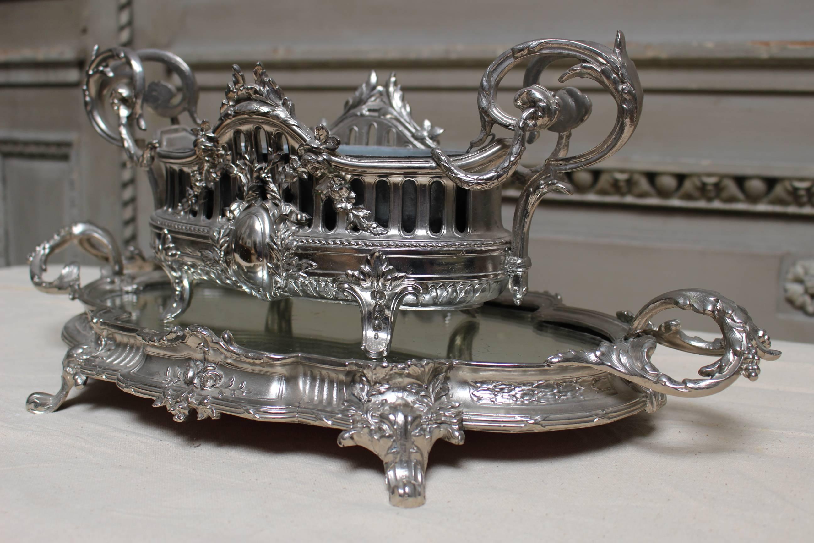 A French Louis XVI style silvered metal jardinière and matching plateau.