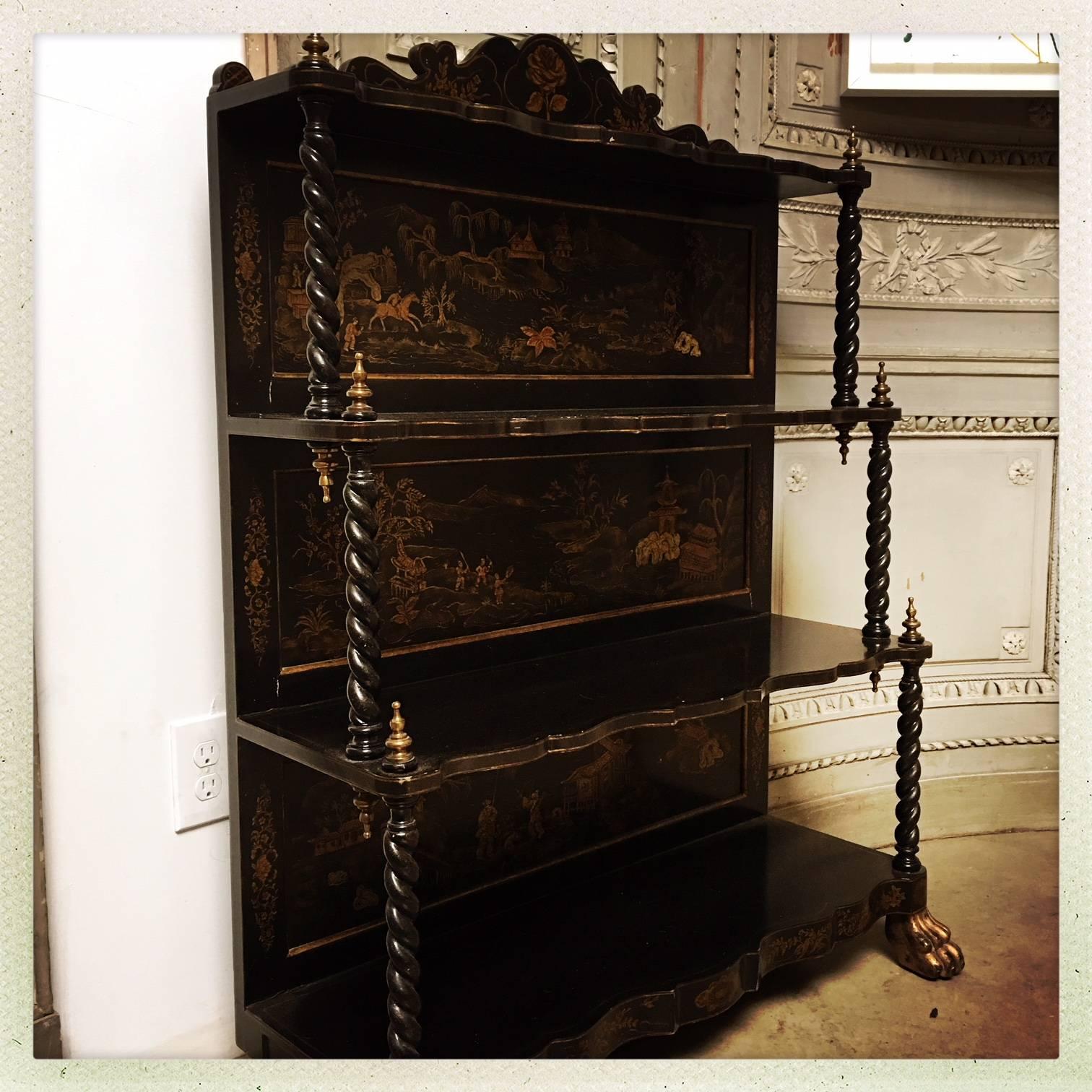 A chinoiserie Victorian style etagere with black lacquer parcel gilding and brass fittings. 
