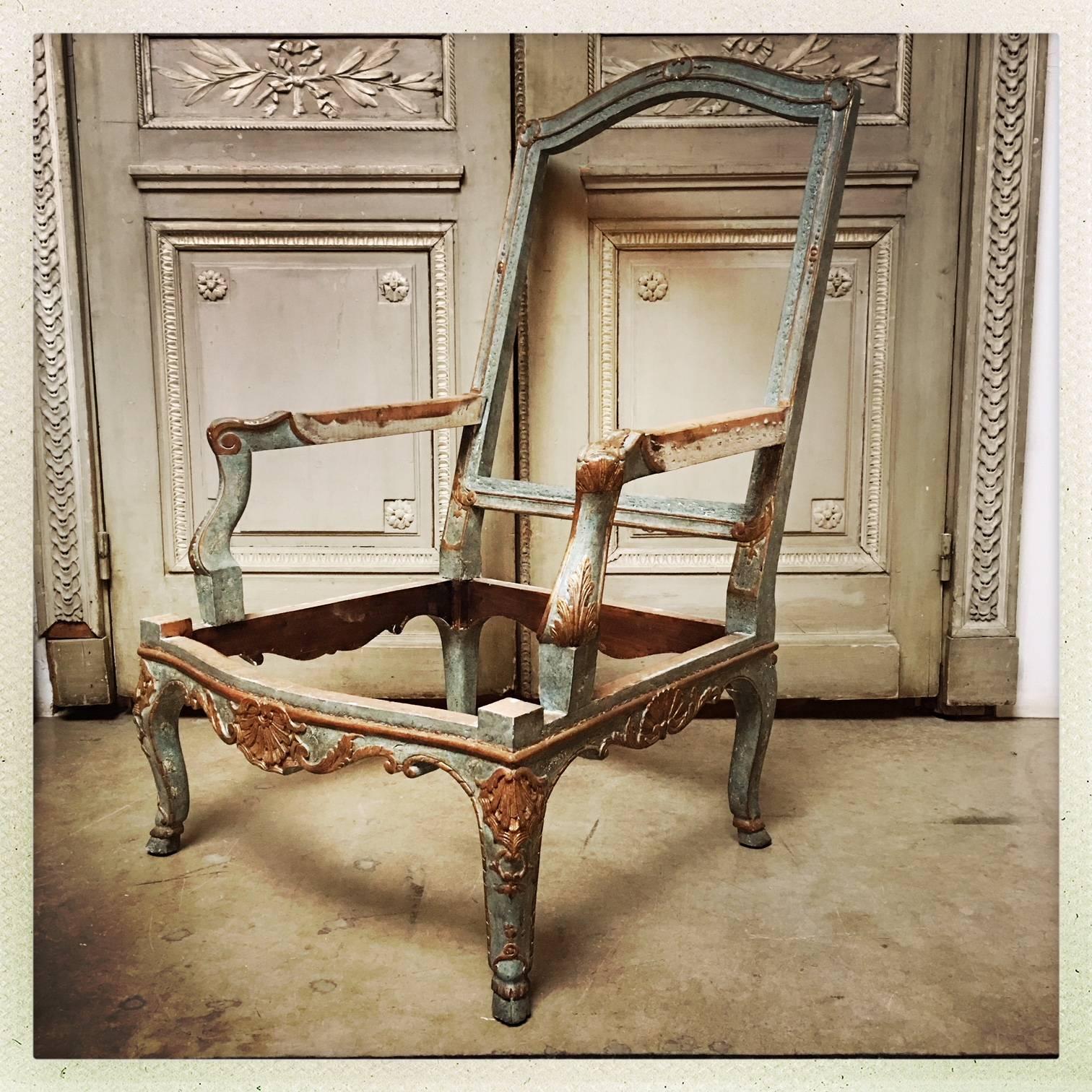 A large pair of French Baroque style Armchair Frames with a blue paint and parcel gilt finish.
This highly decorative pair of chair frames are elegant and large and ready to be upholstered. They have a recent hand painted and gilt finish, but the