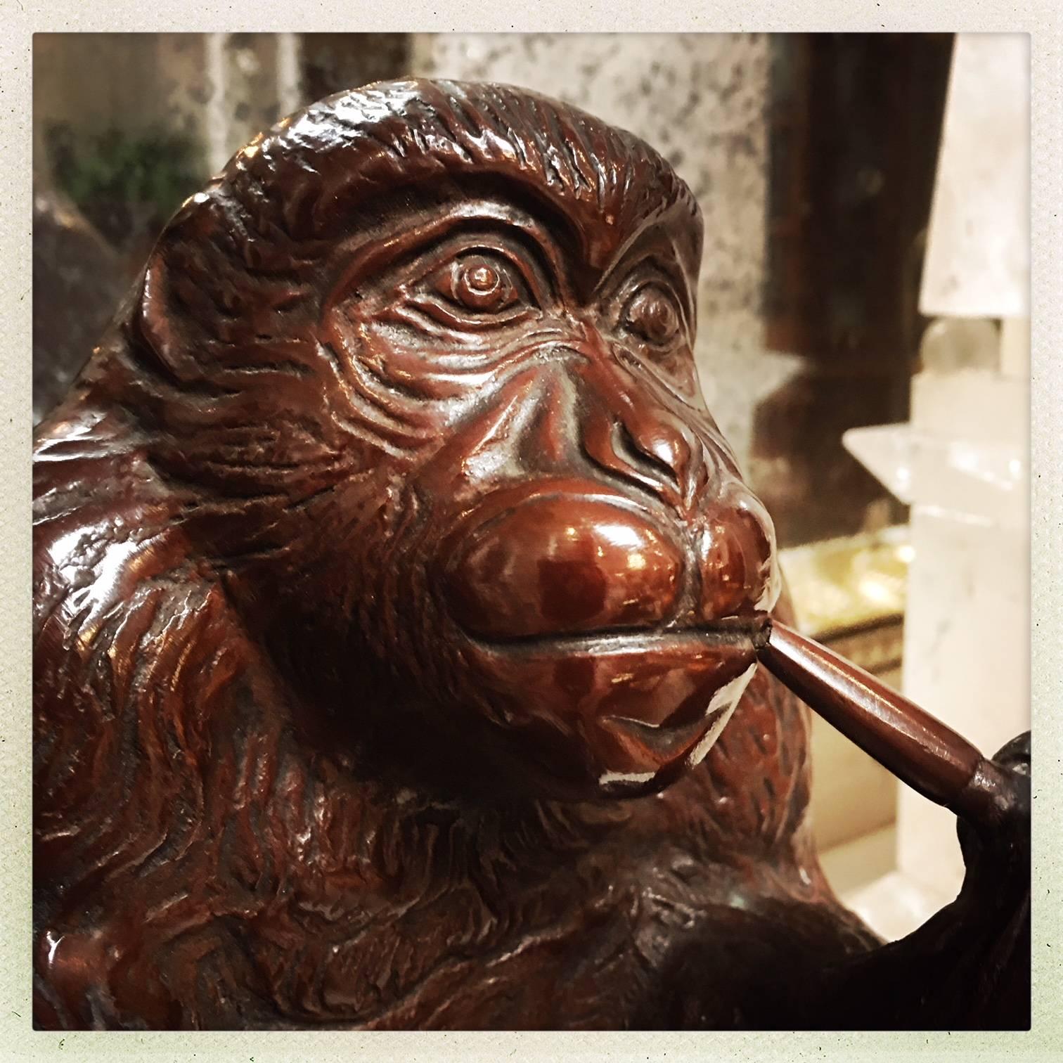 A Japanese bronze monkey smoking a pipe. Early 20th century