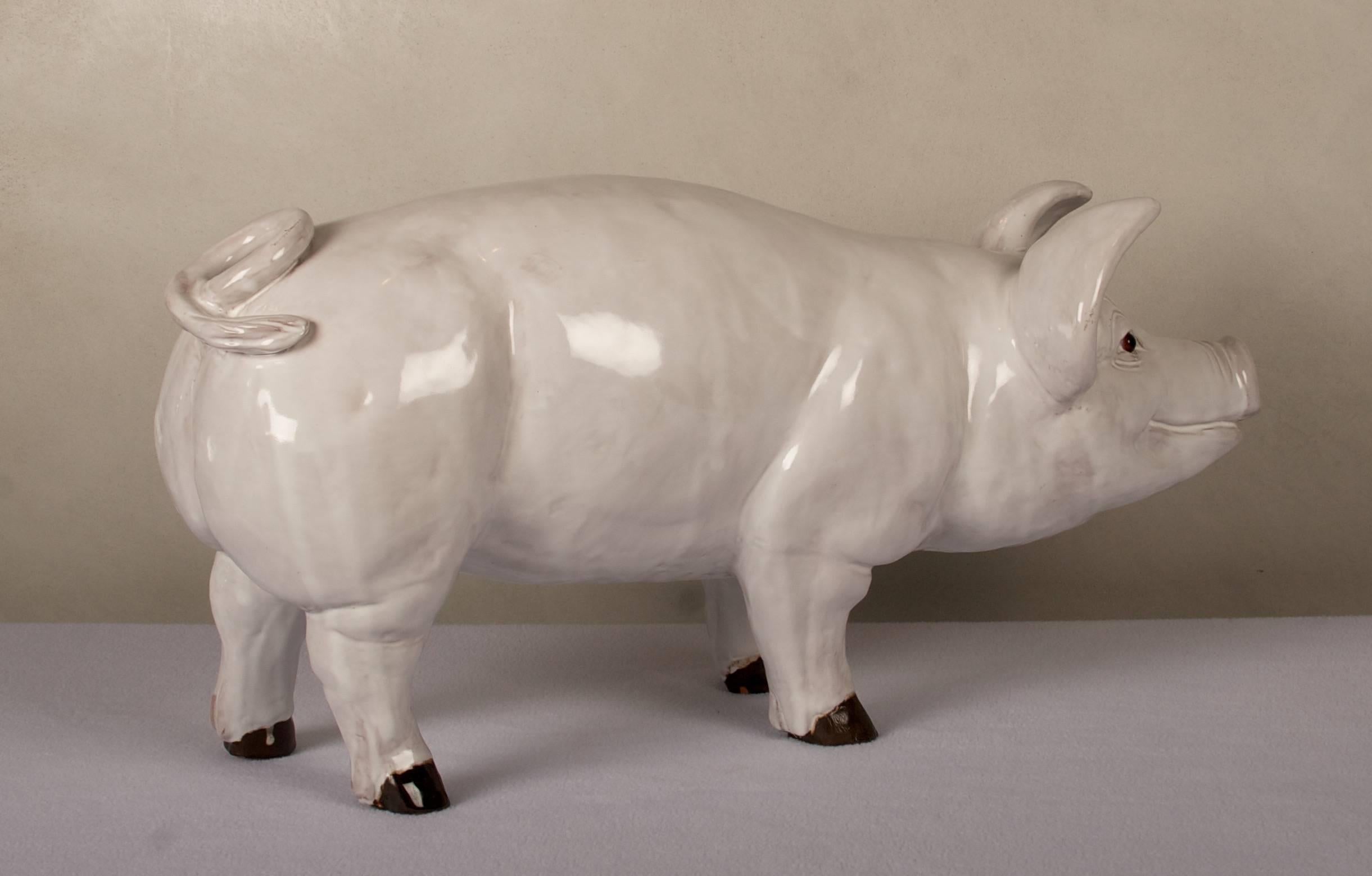 Glazed terra cotta pig with glass eyes, from the turn of the century, French.
Wonderful store display statue. The pig is in very good condition
with no chips or losses.
 