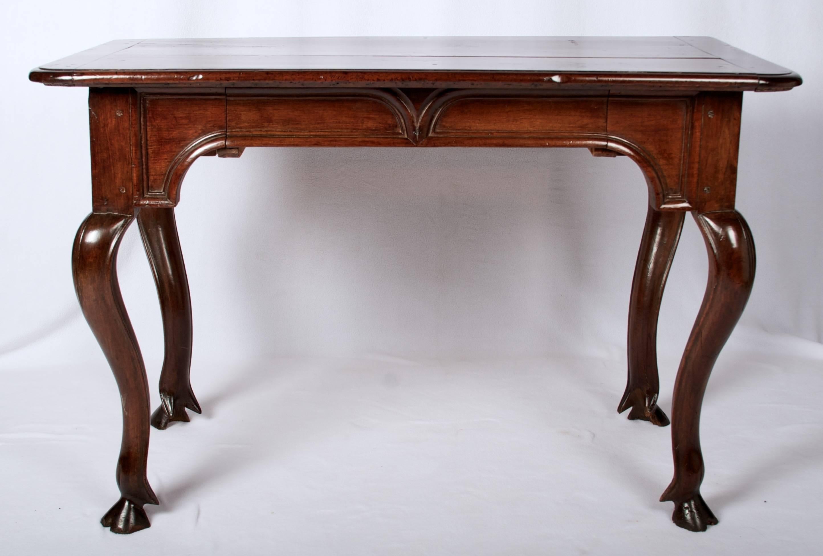 A wonderfully proportioned table with a drawer, from the Lombardy region
of Italy. The goat foot detail on the soft cabriolet leg is reminiscent of the
elaborate carved and gilded consoles of the same period. The finish is
original and has only