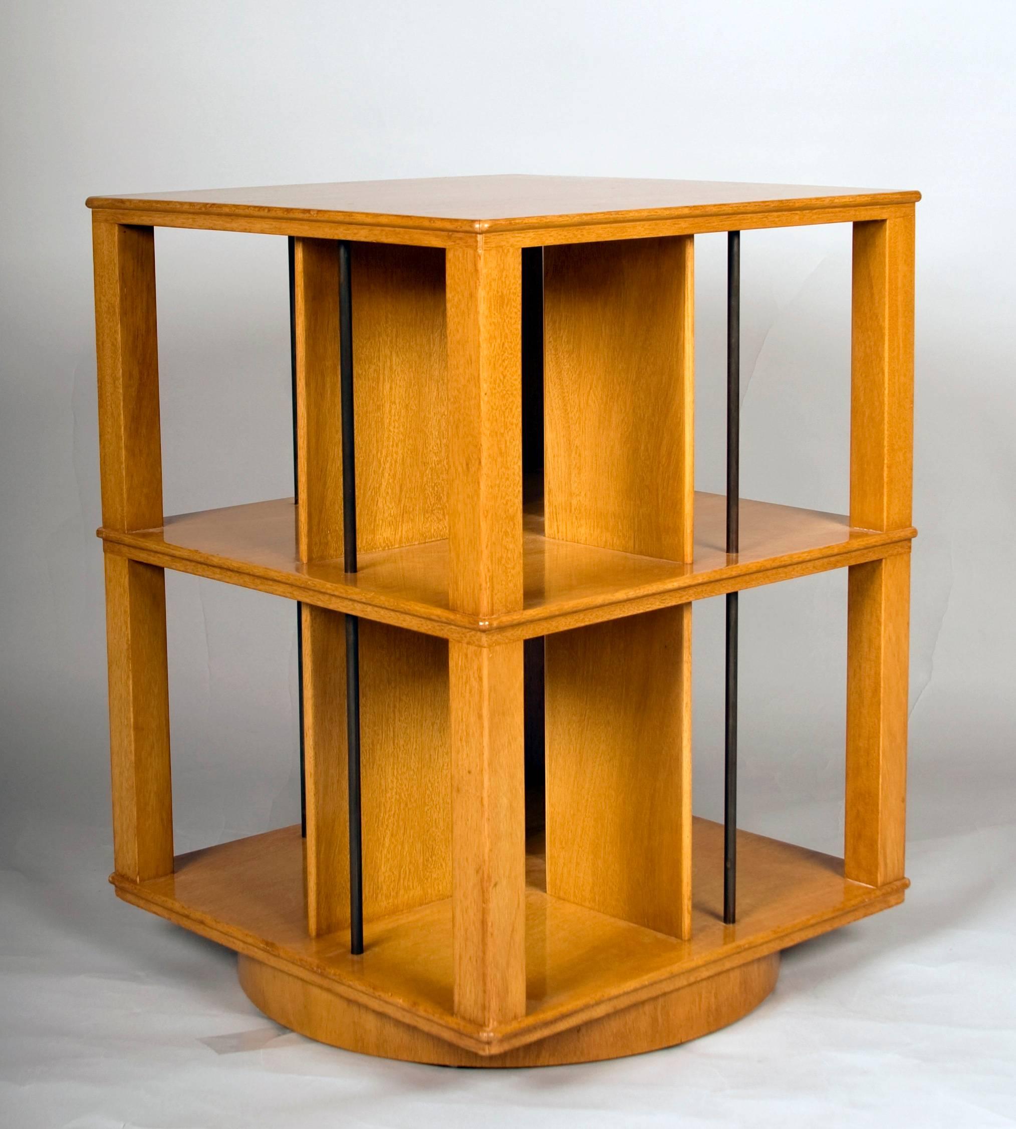 Early Edward Wormley revolving bookcase or table for Dunbar with dividers
and vertical patinated brass rods over a round revolving platform base.
Bookcase retains original 