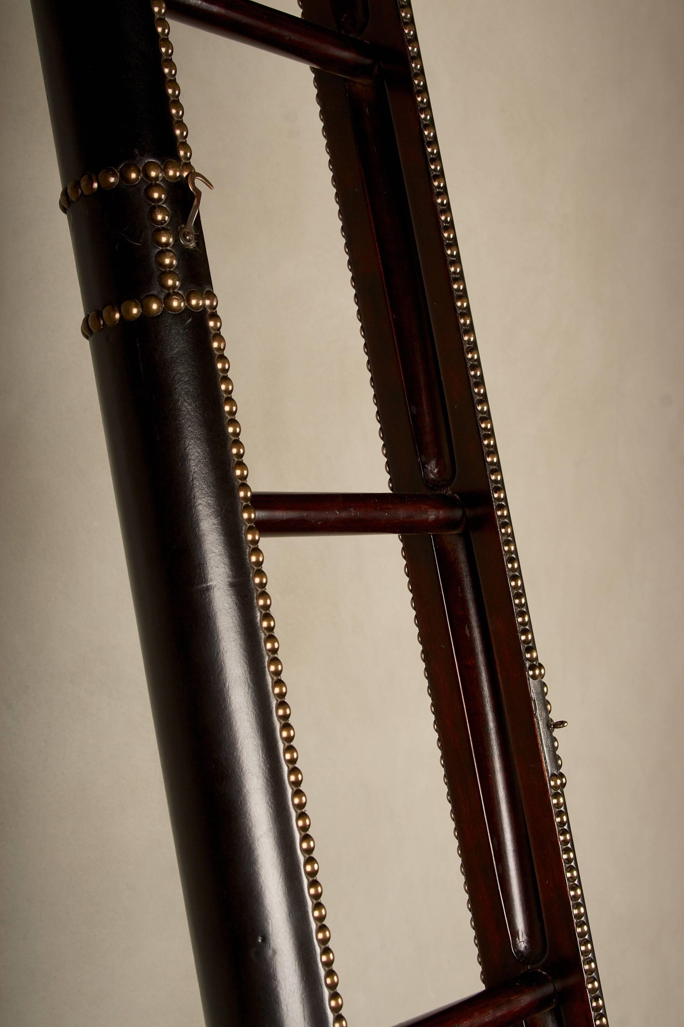 A wonderful 19th century elephant ladder, in fine mahogany with leather
and nailhead trim. The ladder folds into a pole with an ingenious mechanism.
This ladder was once sold by the famous Antonio's Antiques of Jackson
Square, in San Francisco, and