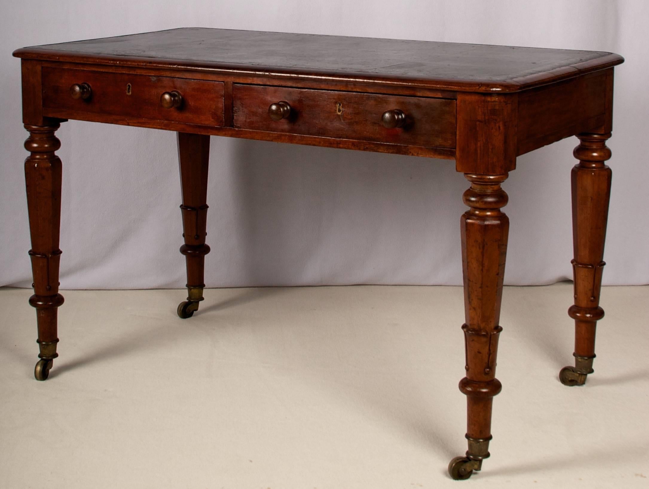 A very handsome English mahogany writing table/ desk that could also
be lovely as a bedside table, especially in a guest bedroom where a
piece like this can also be used for occasional writing.
The desk is of solid mahogany, crossbanded top edge