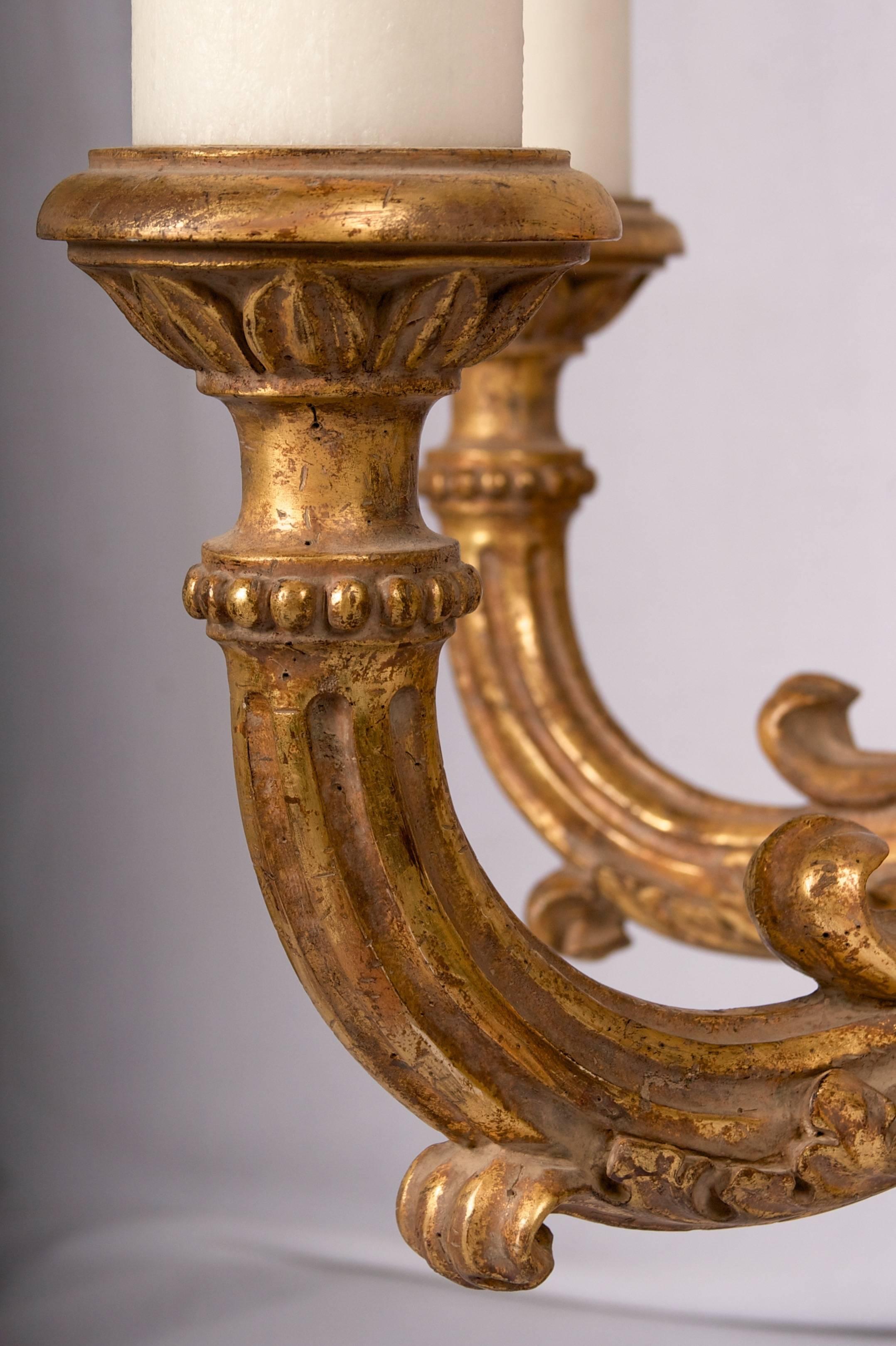 A very substantial hand-carved and gilded chandelier with wonderful wax
candle sleeves and great balanced form.