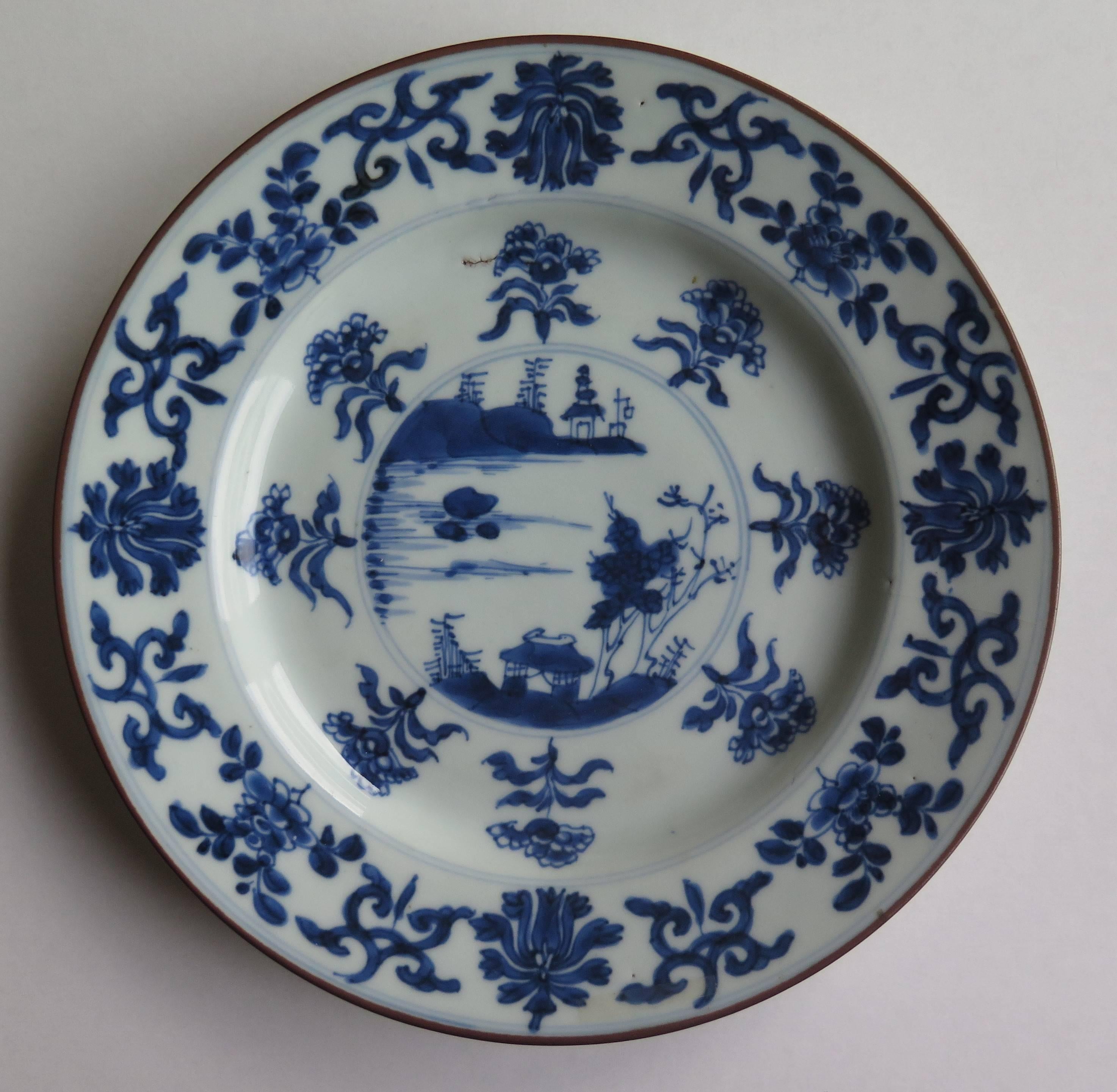 This is a thinly potted, fine hand-painted Chinese porcelain plate.

The glaze is thin and glassy with the decoration in varying shades of a cold steely cobalt blue. 

The outer rim and outer well are decorated with an eight set multi-foliate