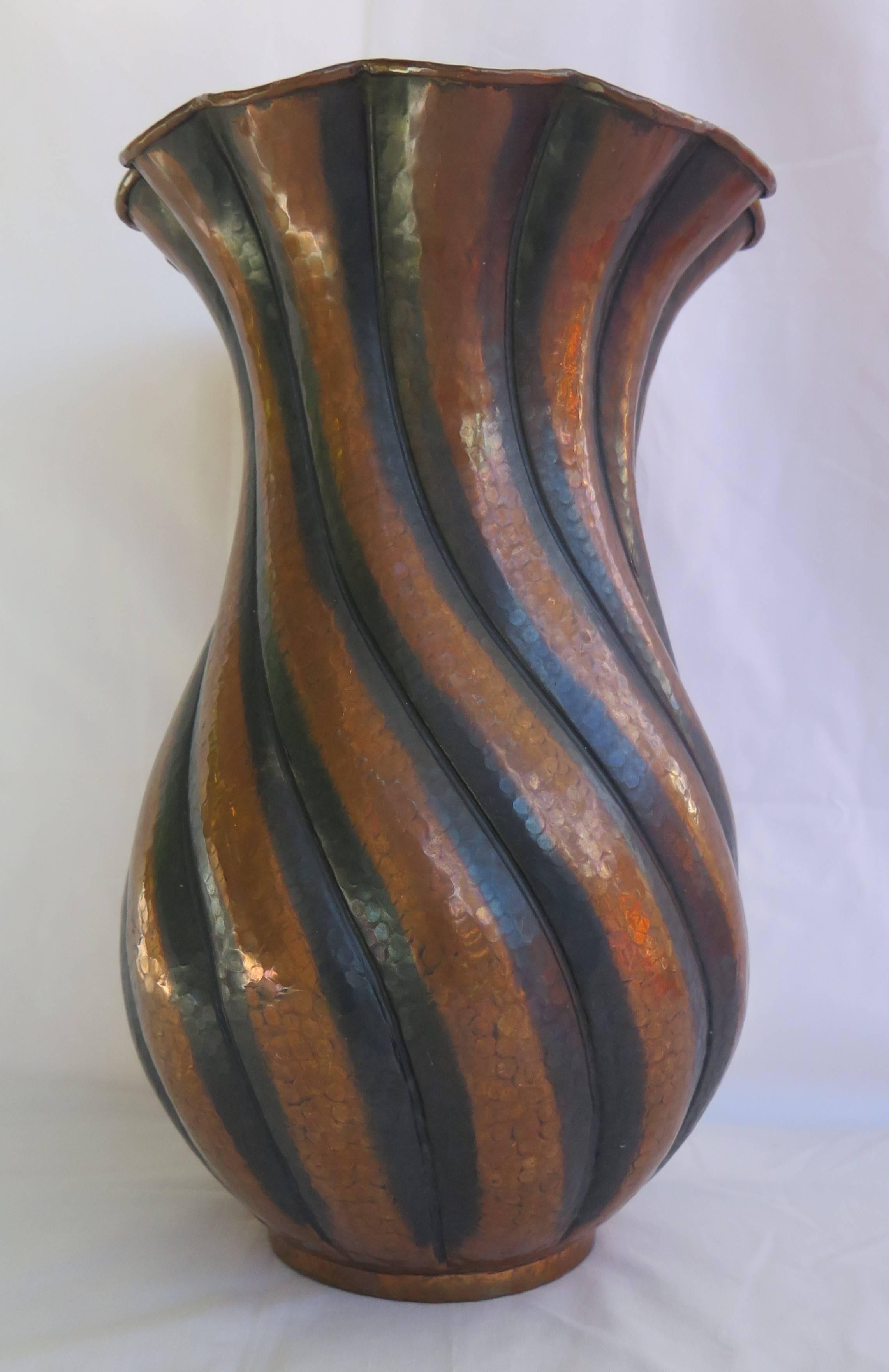 This is an excellent example of a large copper vase by the renowned Italian designer and metalworker, Egidio Casagrande.

The vase is hand worked in hammered copper and has a shallow foot below a baluster shape with vertical twist fluting, leading