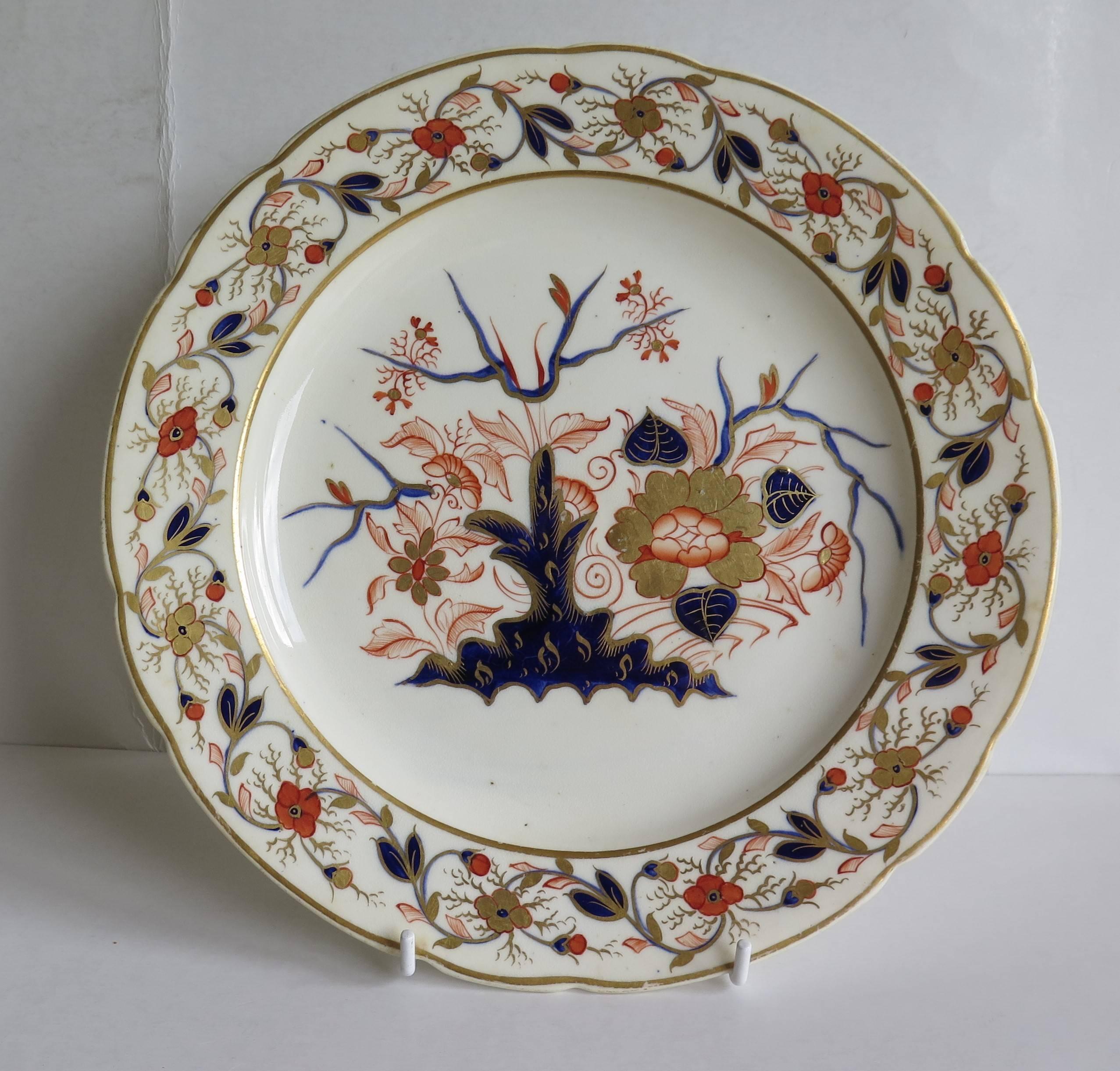 This is a very good early dinner plate from the Derby porcelain factory from the late Georgian period , Ca 1830.

The decoration consists of a continuous intertwining floral sprig border pattern and a central floral pattern set among rocks in the