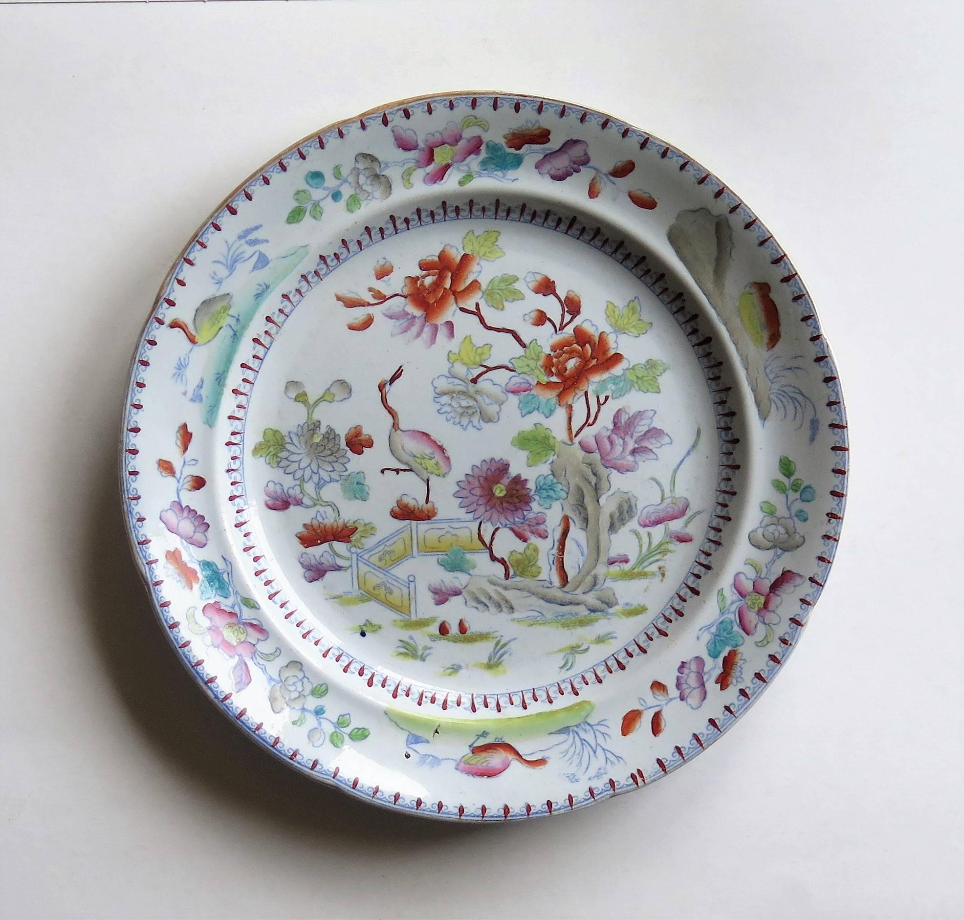 This a very good dinner plate made by William Davenport & Co., Longport, Staffordshire Potteries, England, circa 1810.

The plate is carefully hand-painted over a printed outline in a bold Imari, Japan pattern No. 27. The design highlights a Crane