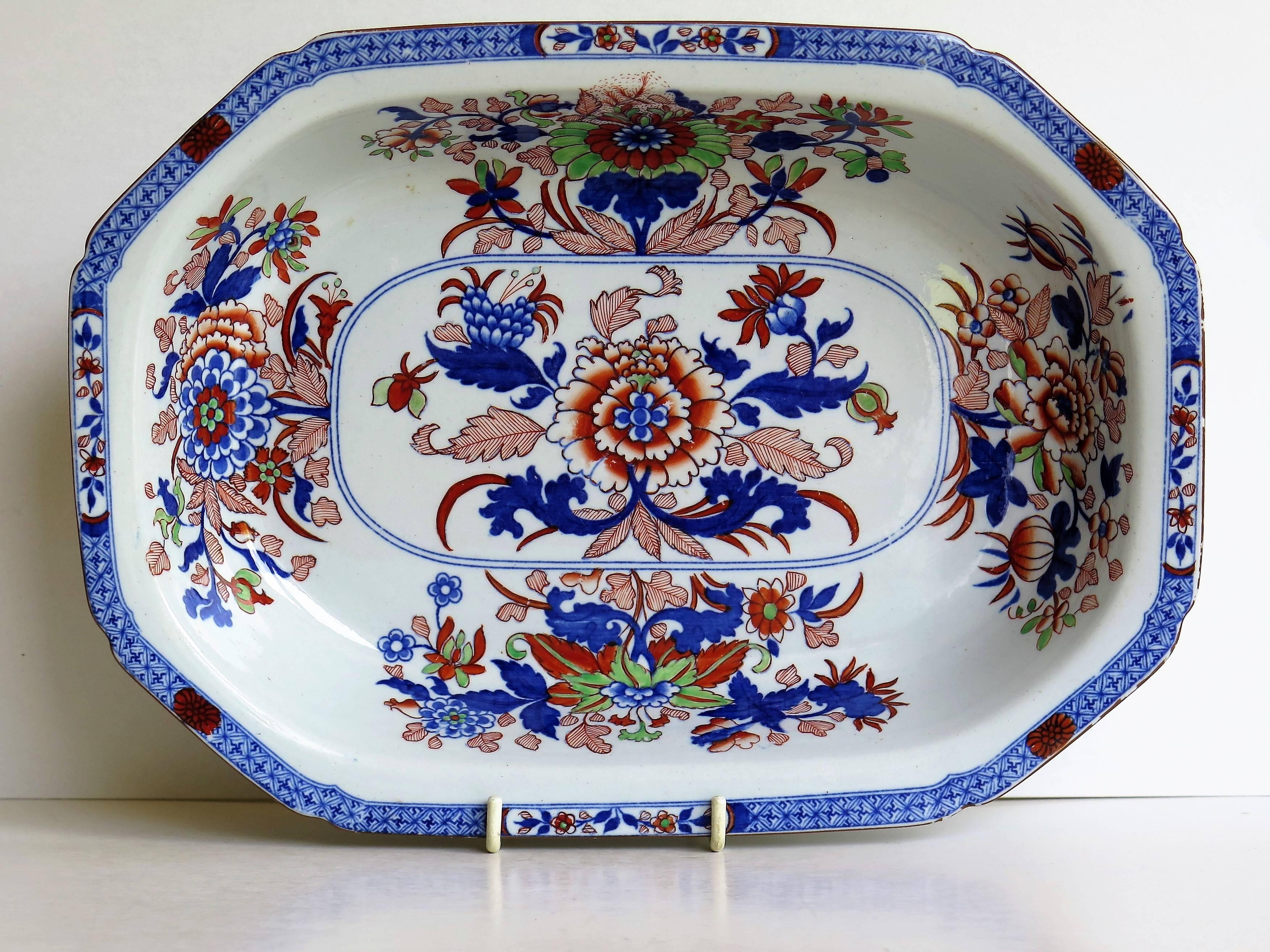 This is a beautiful large serving dish, produced by the Spode factory in pattern number 2054. This is a fairly deep dish. 

The chinoiserie inspired decoration was transfer printed in cobalt blue under-glaze, then carefully and beautifully