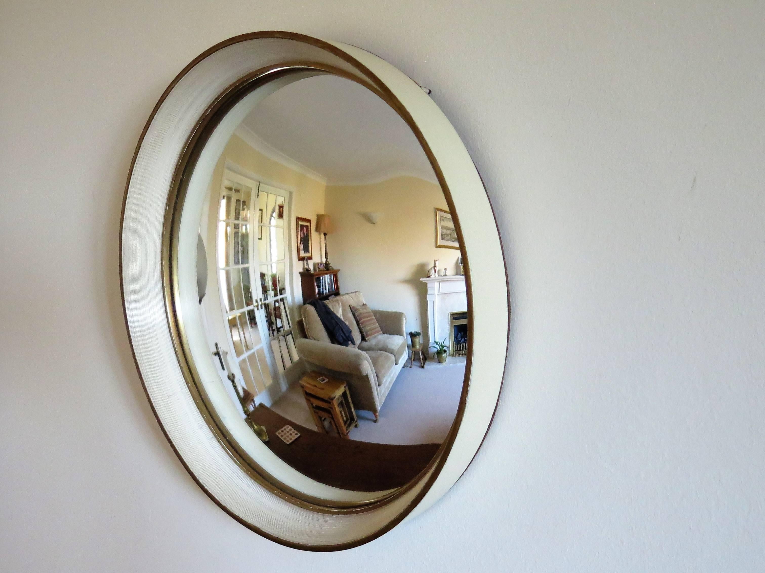 This is a good quality wall mirror with a convex glass and unusual frame detail.

The frame is made of turned wood. The front has a slight outer taper with the outer front diameter being about 13.38 inches and the outer back diameter, slightly