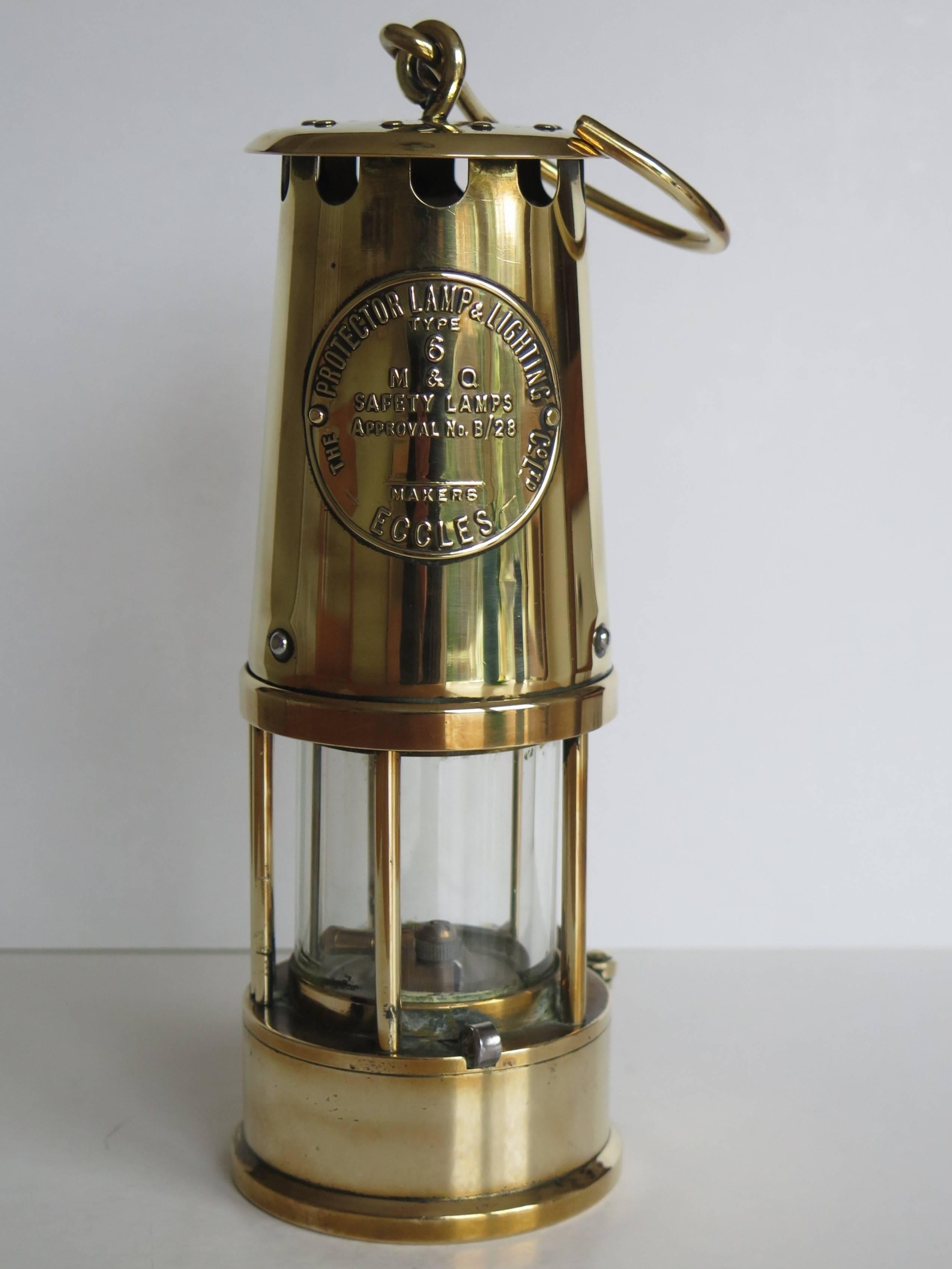 This is a very good, all brass, Miner's Lamp produced by The Protector Lamp and Lighting Company of Monton, Eccles, near Manchester, England, dating to the early / mid 20th Century, circa 1930.

This lamp is the Eccles Type 6 which is a flame safety