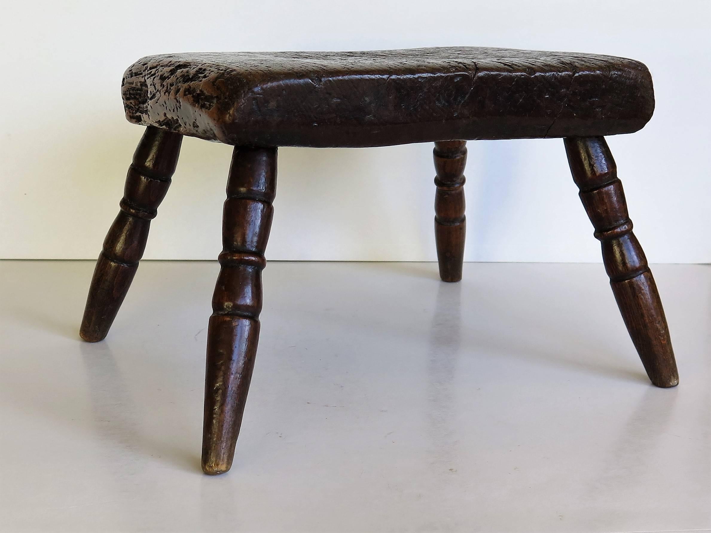 This is a late 18th century candle stand or stool and is a good example of English Country furniture.

The thick rectangular top is made of solid elm and has a chamfered lower edge. The legs are particularly good and are of narrow proportions