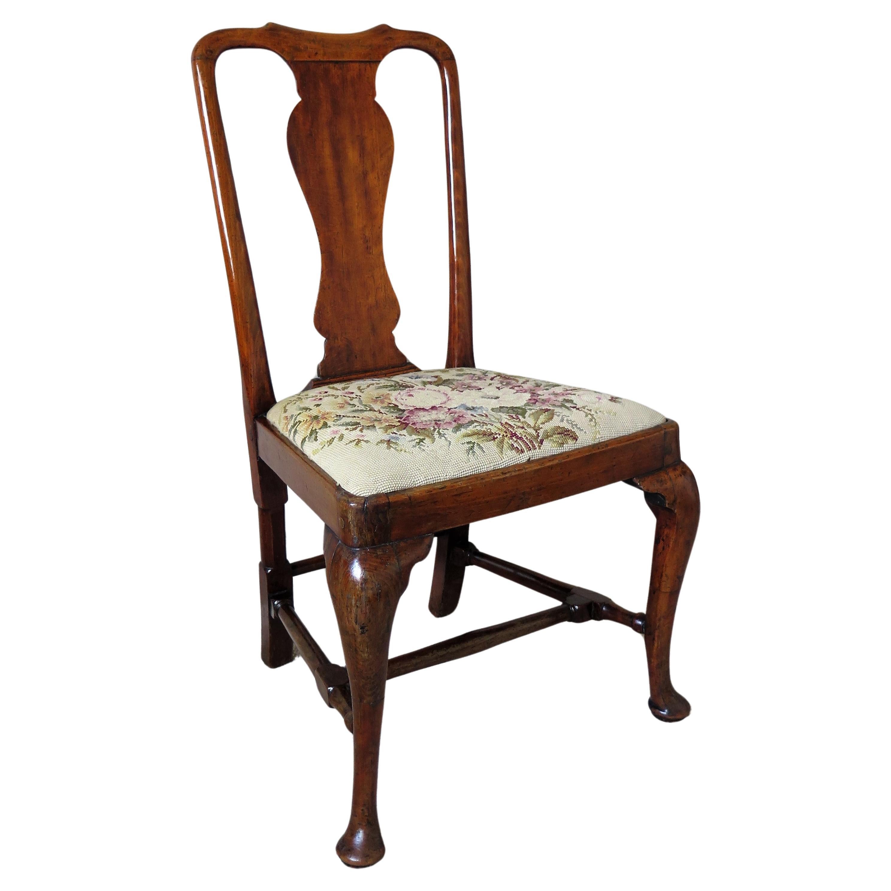 This is a classic English walnut chair from the Queen Anne period with a beautiful mellow color and dating to circa 1700-1710.

This is a very good example of this classic antique design with great character. It has a jointed and pegged