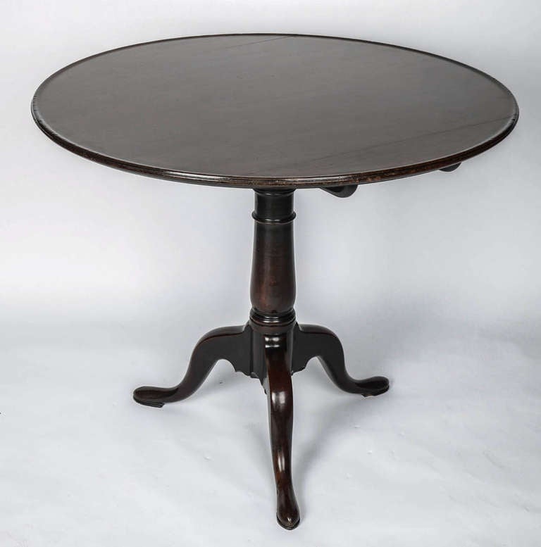 This is a lovely quality English tripod table with a larger diameter, often called a centre or tea table, made of heavy dense Cuban mahogany and dating to the George II period, circa 1740-1750. 

The table is in the manner of Thomas Chippendale