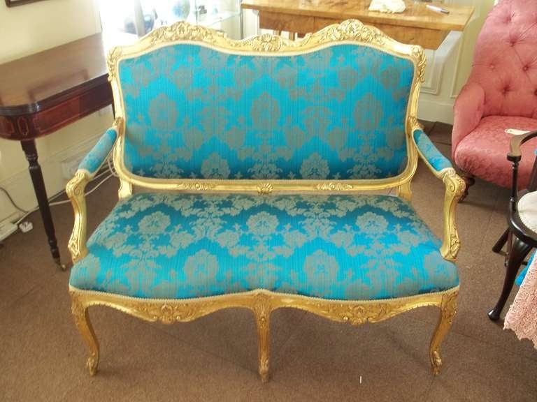 This is a high quality elegant, English settee or sofa in the French Hepplewhite revival or Louis XV style, made in the mid-19th century and reupholstered in a silk brocade damask fabric.

It has a good shaped giltwood frame with a lovely flowing