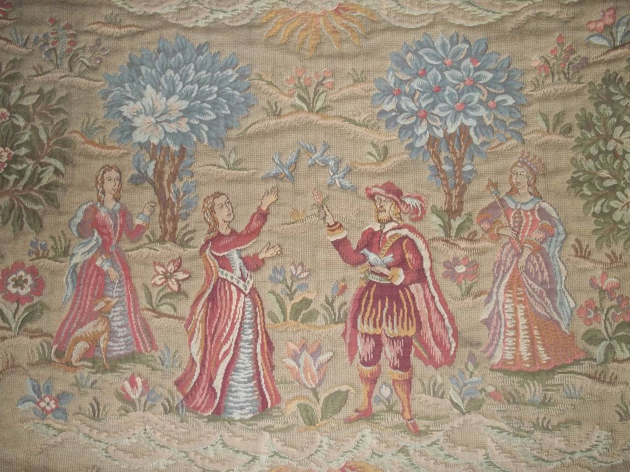 This is a large and beautiful antique French Jacquard woven wool tapestry, in the Aubusson style, dated around the mid-19th century, circa 1850.

The design depicts a gathering of people in a woodland setting – perhaps a king and queen with
