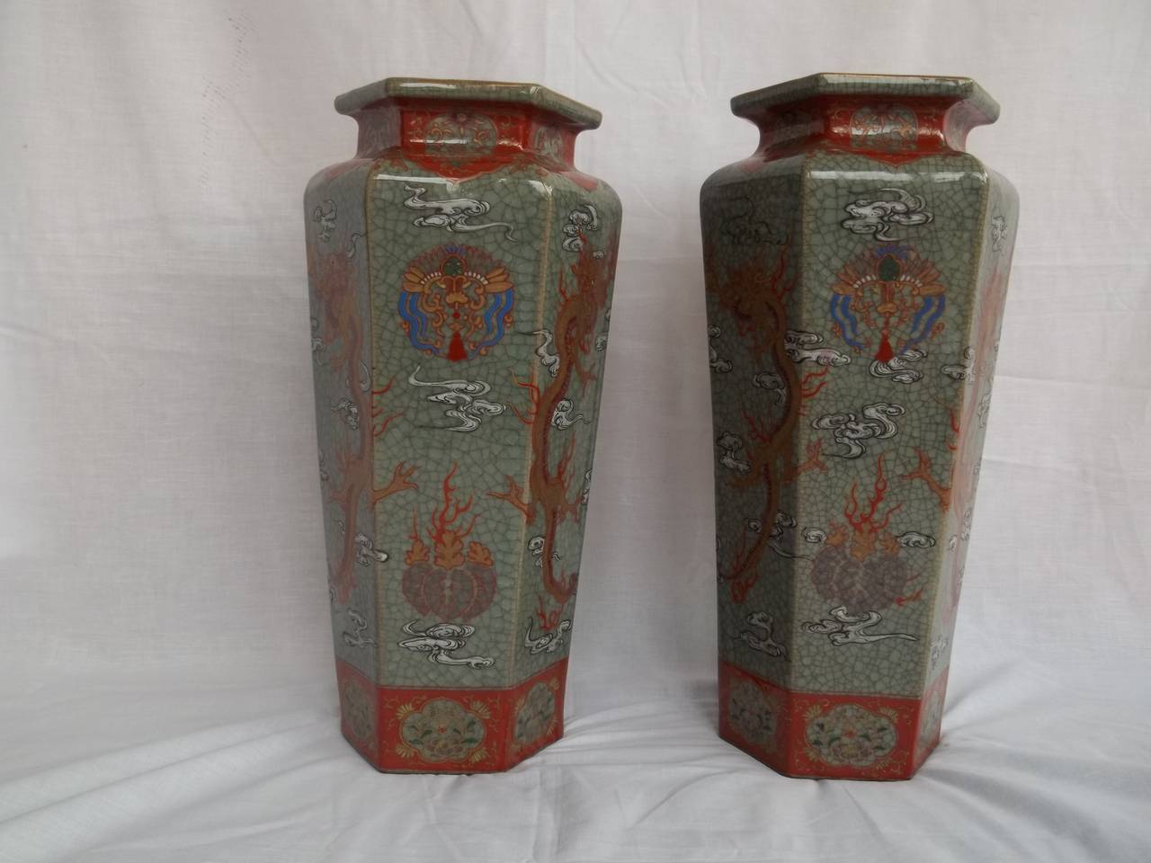 These are a PAIR of very beautiful, decorative Chinese porcelain Vases hand painted with dragons, that we date to the late Qing period, circa 1900.

The vases are hexagonal in section, tapering towards the base, with a high neck and have a celadon,
