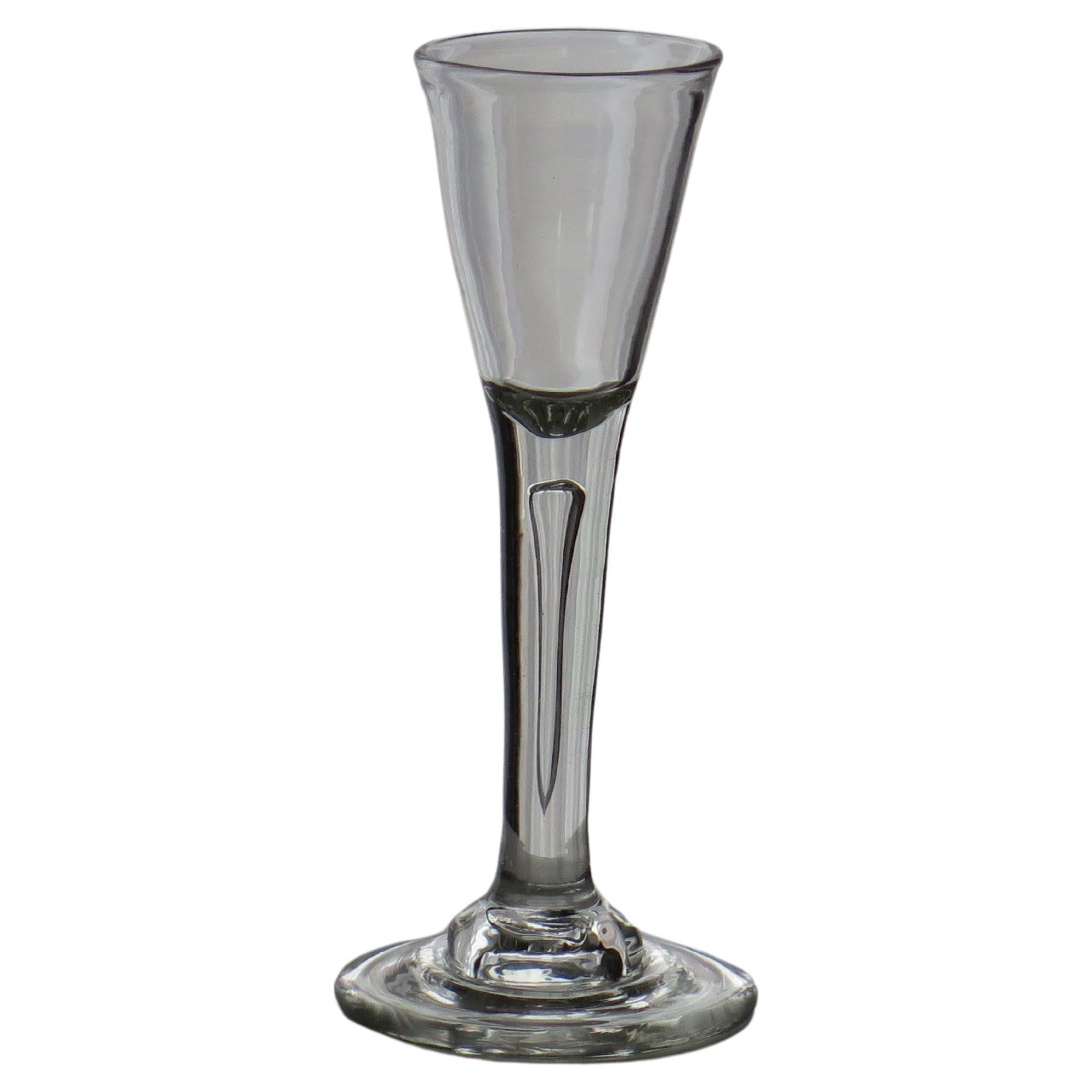 This is a very good, tall, English, mid-Georgian, hand blown, wine drinking glass, dating to the George II period of the mid-18th century, circa 1740.

These 18th Century hand blown drinking glasses are uniquely individual and very