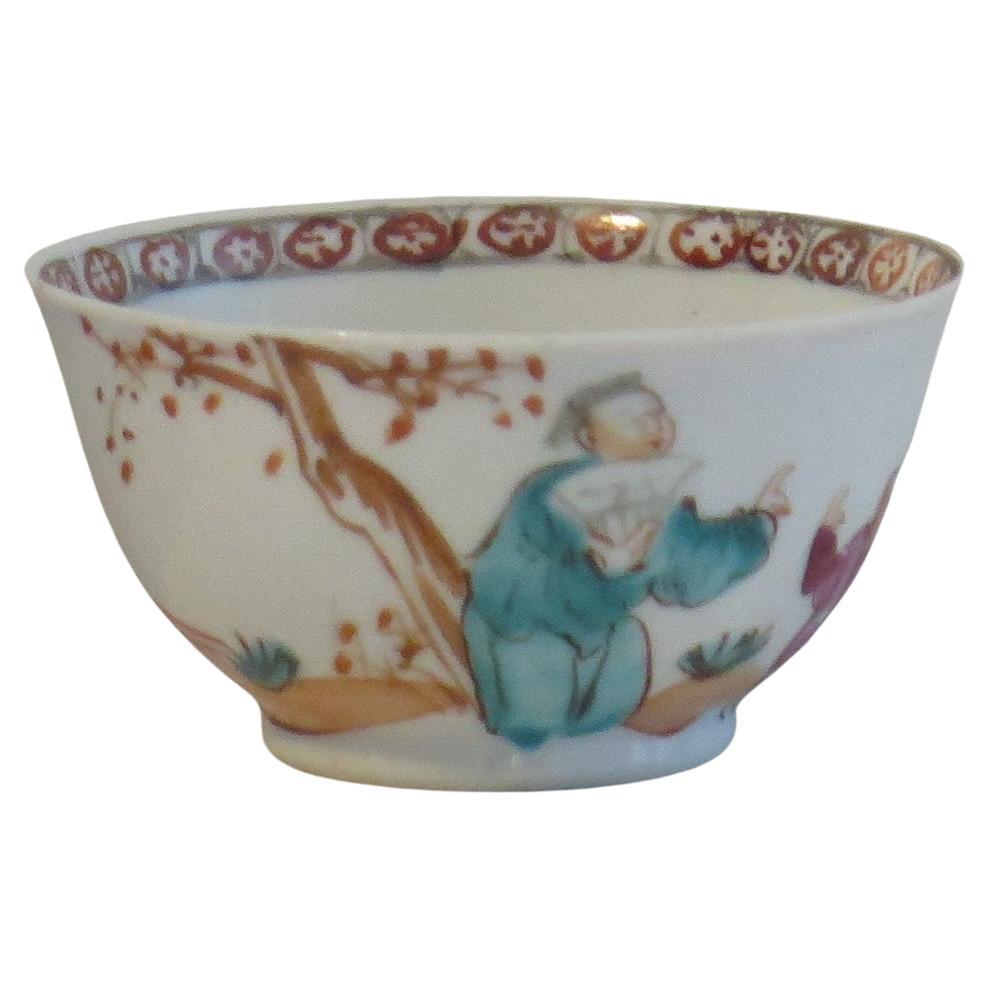 This is a finely hand painted Chinese porcelain tea bowl from the 18th century, Qing dynasty, Qianlong period, 1736-1795.

The bowl is well decorated, continuously around the body with figure scenes in an outdoor verandah setting having a fence,