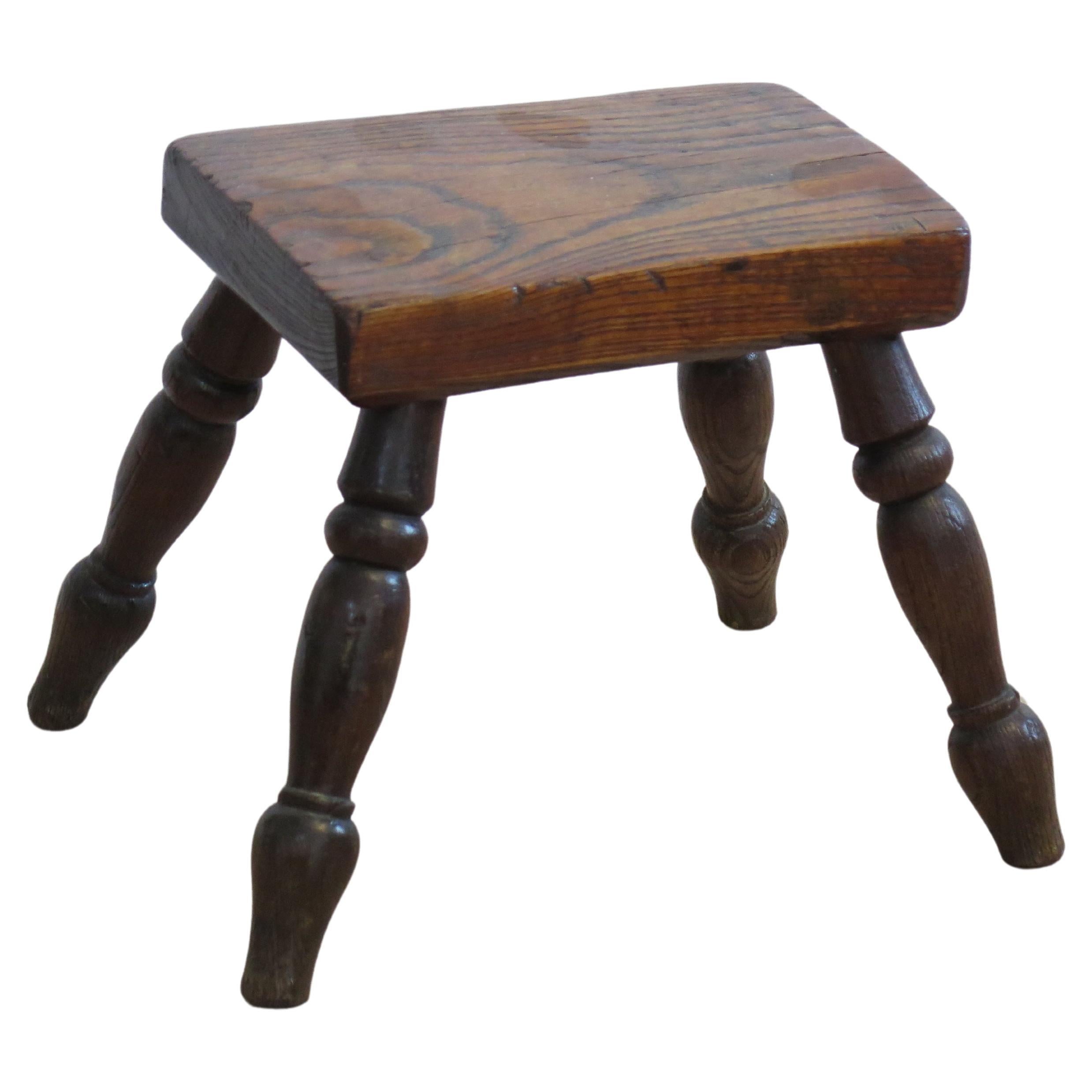 This candle stool is a very good example of English Country furniture with a lovely polished elm top. 

The thick rectangular top is made of solid elm and has a lower chamfered edge. The legs are made from ash or elm and are well turned, typical