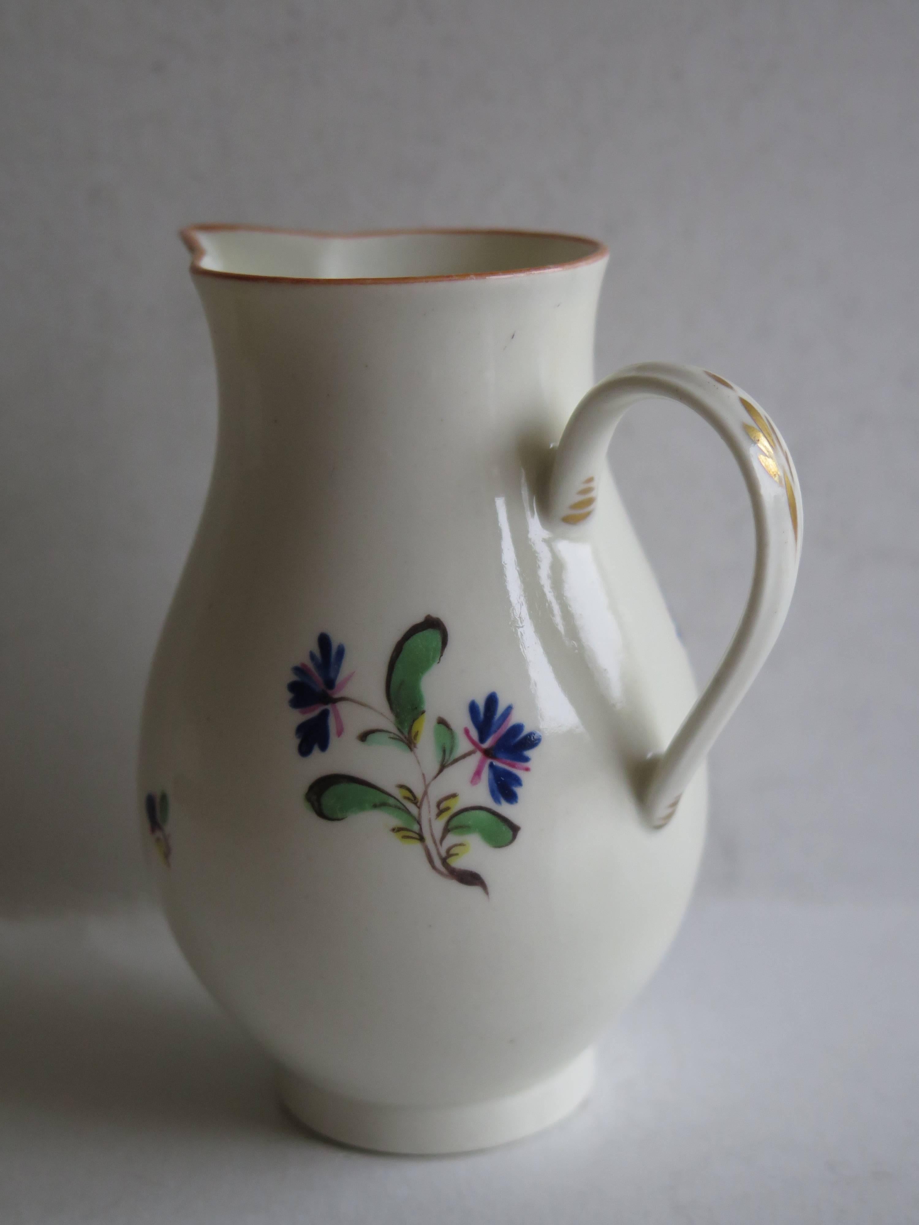 This is a rare, soft-paste porcelain, sparrow beak milk jug by the Caughley Porcelain factory, Shropshire, England.

The jug is beautifully hand decorated in the French influenced Chantilly style with simple delicate floral sprig motifs, painted