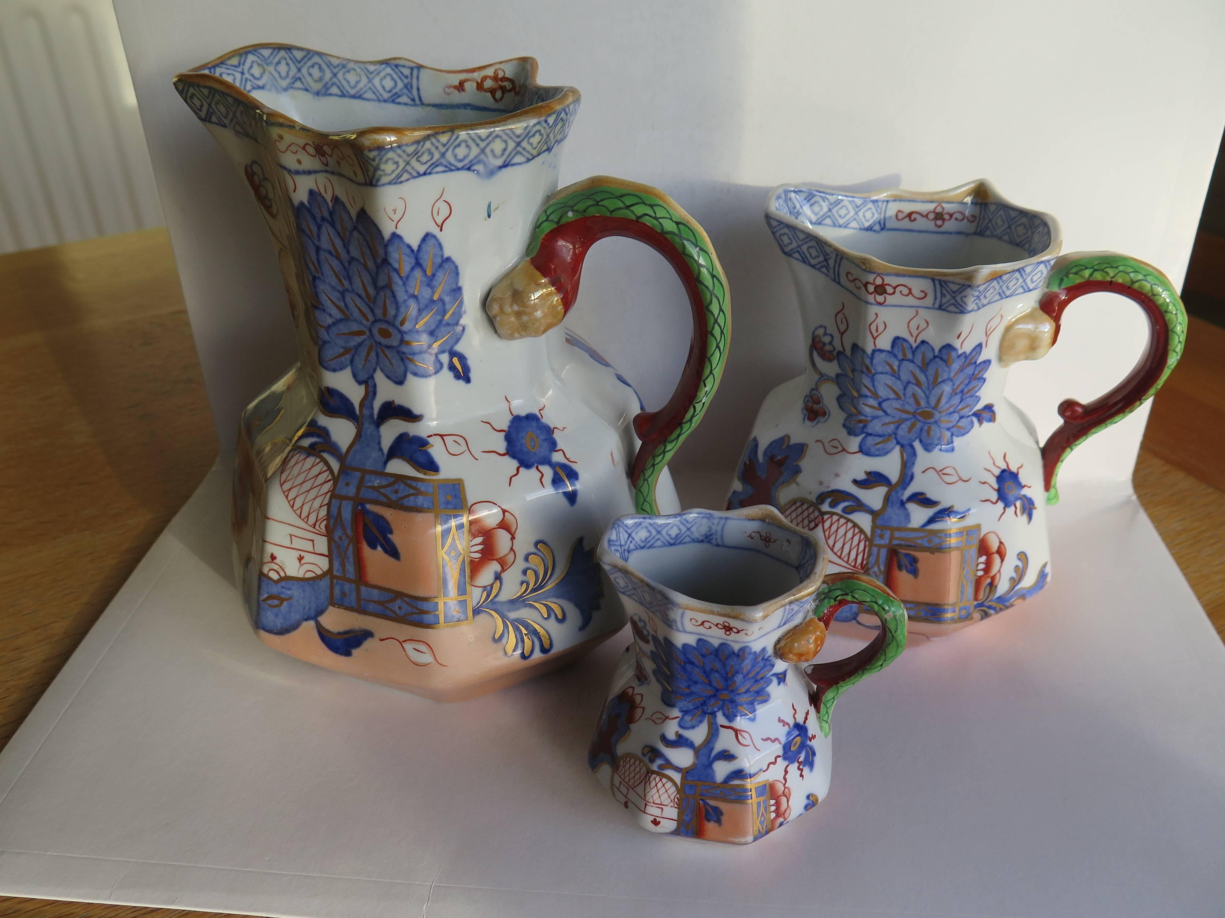 Graduated trio of MASONS IRONSTONE Hydra Jugs or Pitchers - ALL in the JARDINIERE  PATTERN
The pattern features an octagonal flower box with a large floral stem and apple shape growing from it. The apple contains an outline of a two storey Chinese