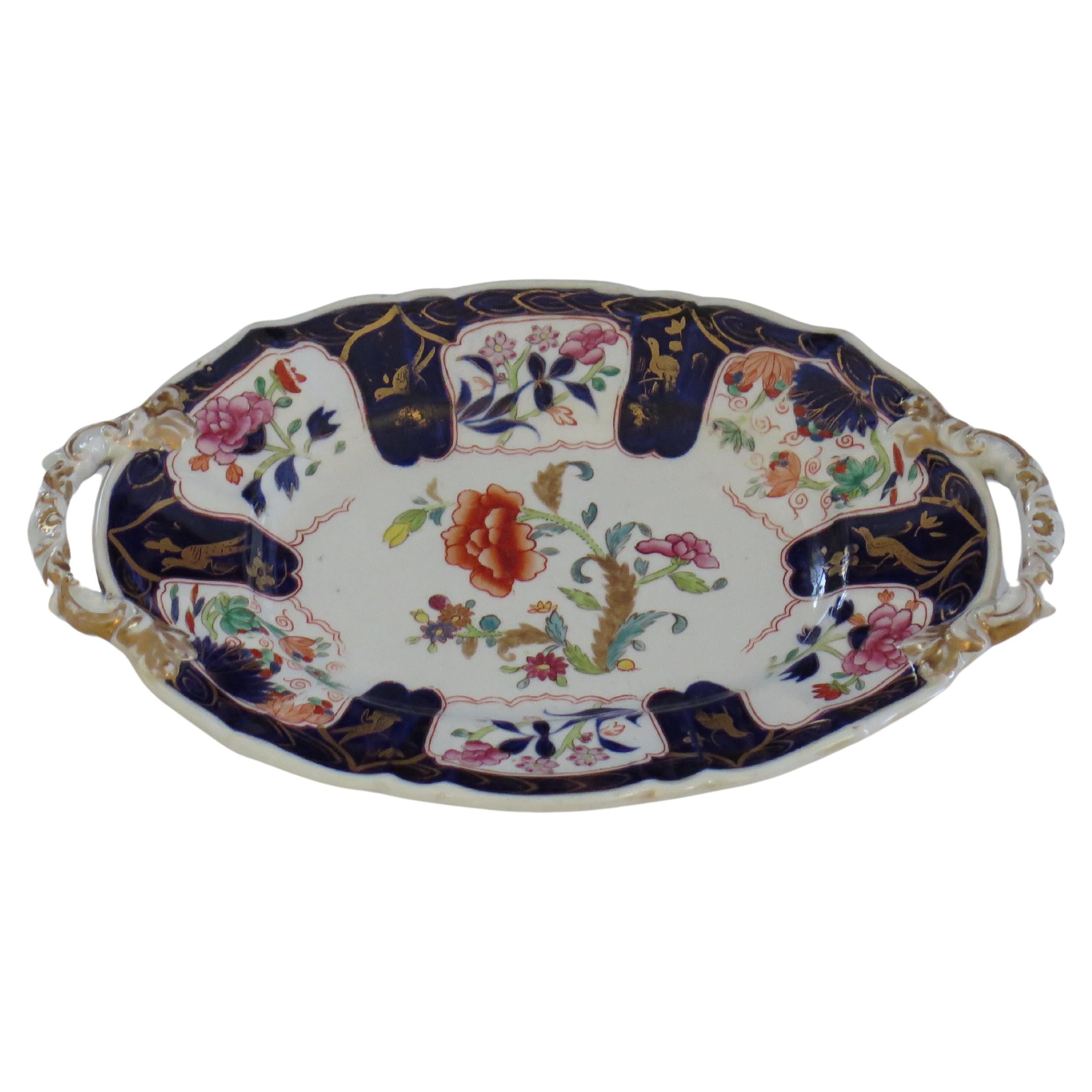 This is a very good hand painted Mason's ironstone oval Platter, in the Gold Pheasants, Peony & Fern pattern, dating to the late Georgian period   circa 1820.

The piece is well potted with an oval shape having radial ribs, a wavy edge and two