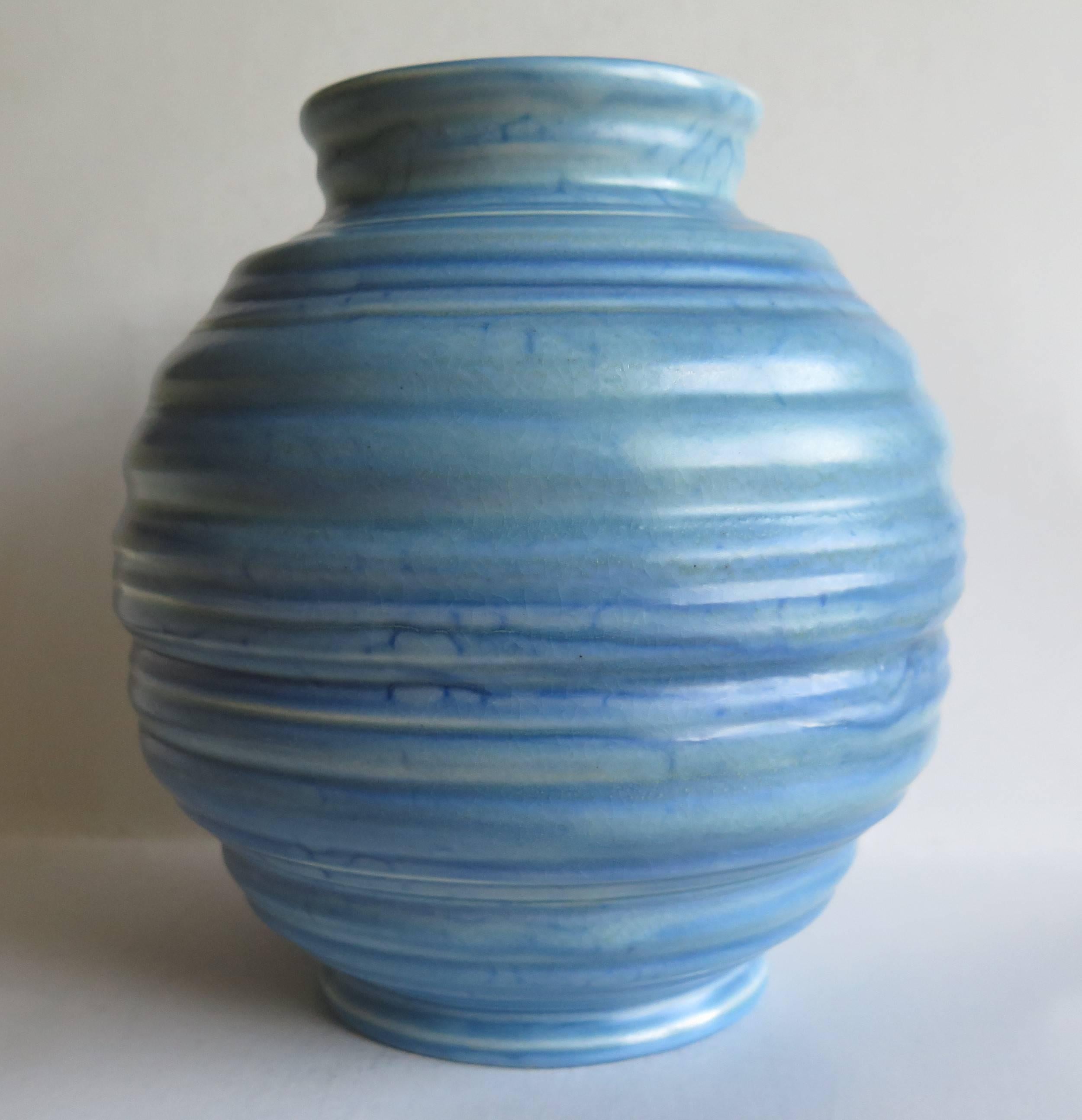 This is a good vase made by Carlton Ware, Carlton Works, Stoke on Trent, Staffordshire, England in the Art-Deco Period, circa 1930.

The earthenware vase has a geometric globular shape on a small foot and is of hand made coiled construction. The
