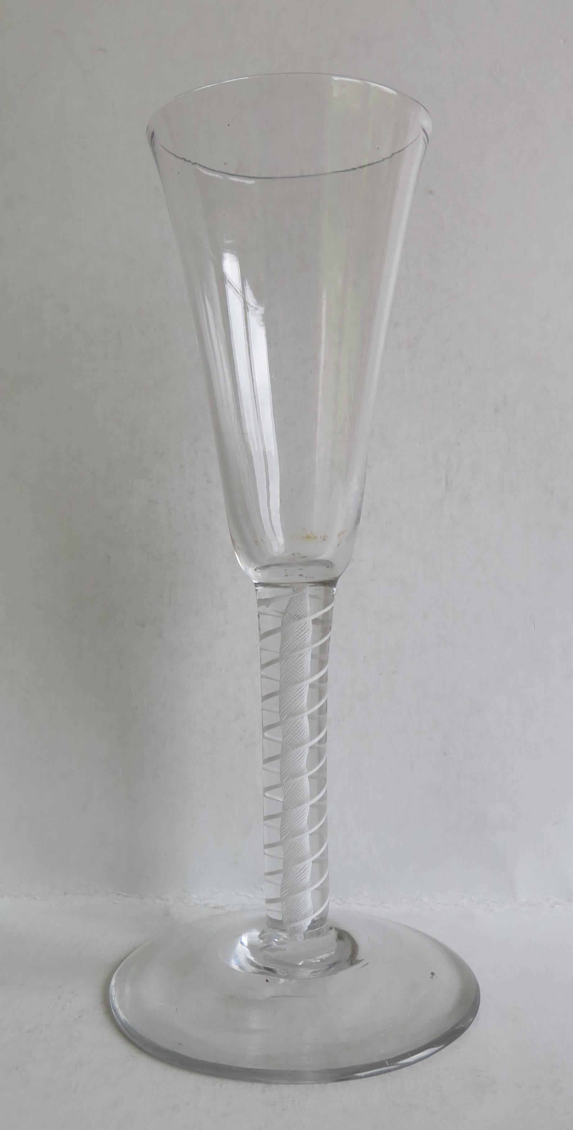 This is a good handblown, English, mid-Georgian, Ale drinking glass with a double series opaque twist (DSOT) stem, dating from the middle of the 18th century, circa 1765. These tall ale glasses are now used as Wine flutes.

These glasses are very