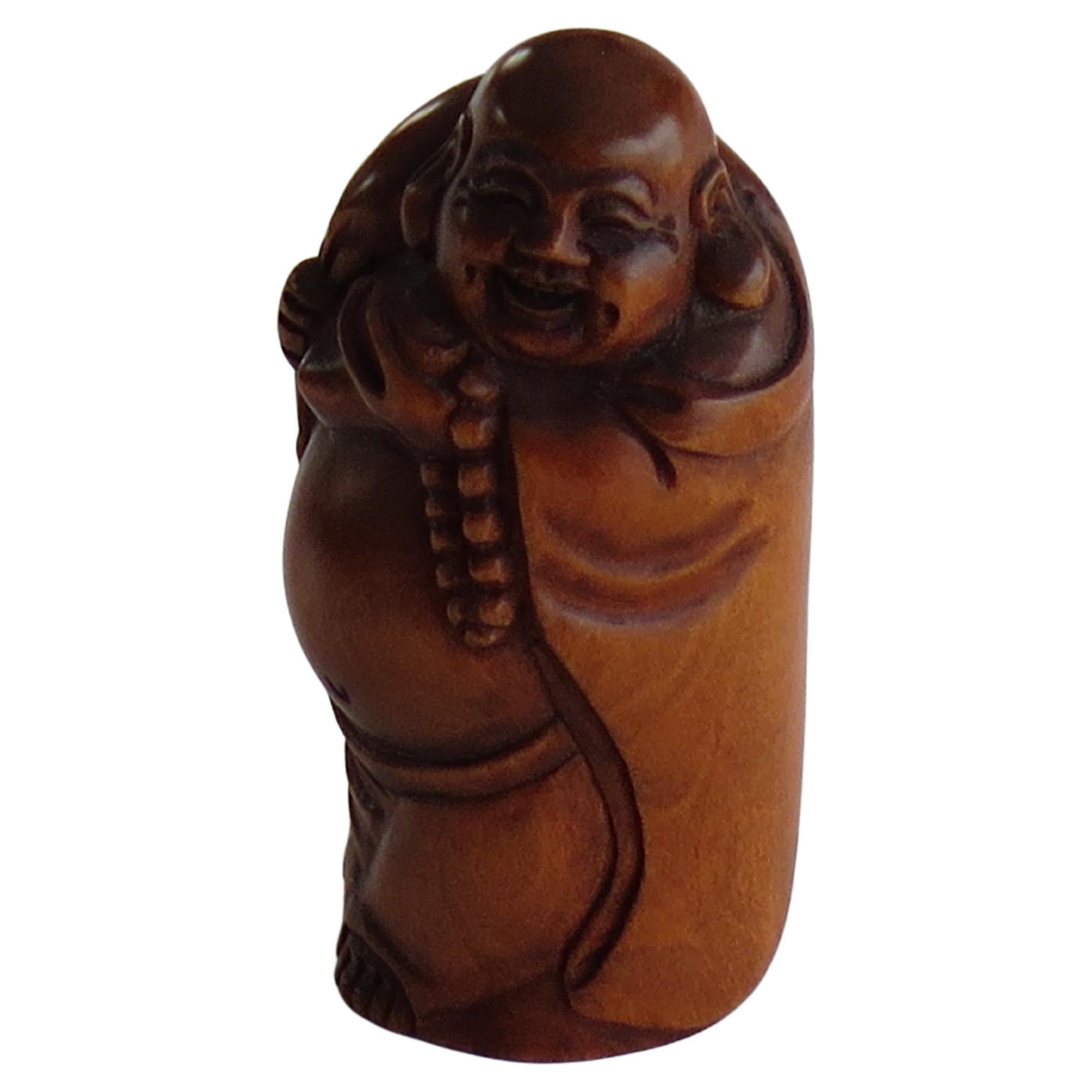This is a boxwood Netsuke, modelled as a Sage, probably Chinese, which we attribute to a Japanese maker, circa 1900.

This piece is of good quality and very well hand carved, showing a Chinese sage or immortal with a long flowing cloak. He is