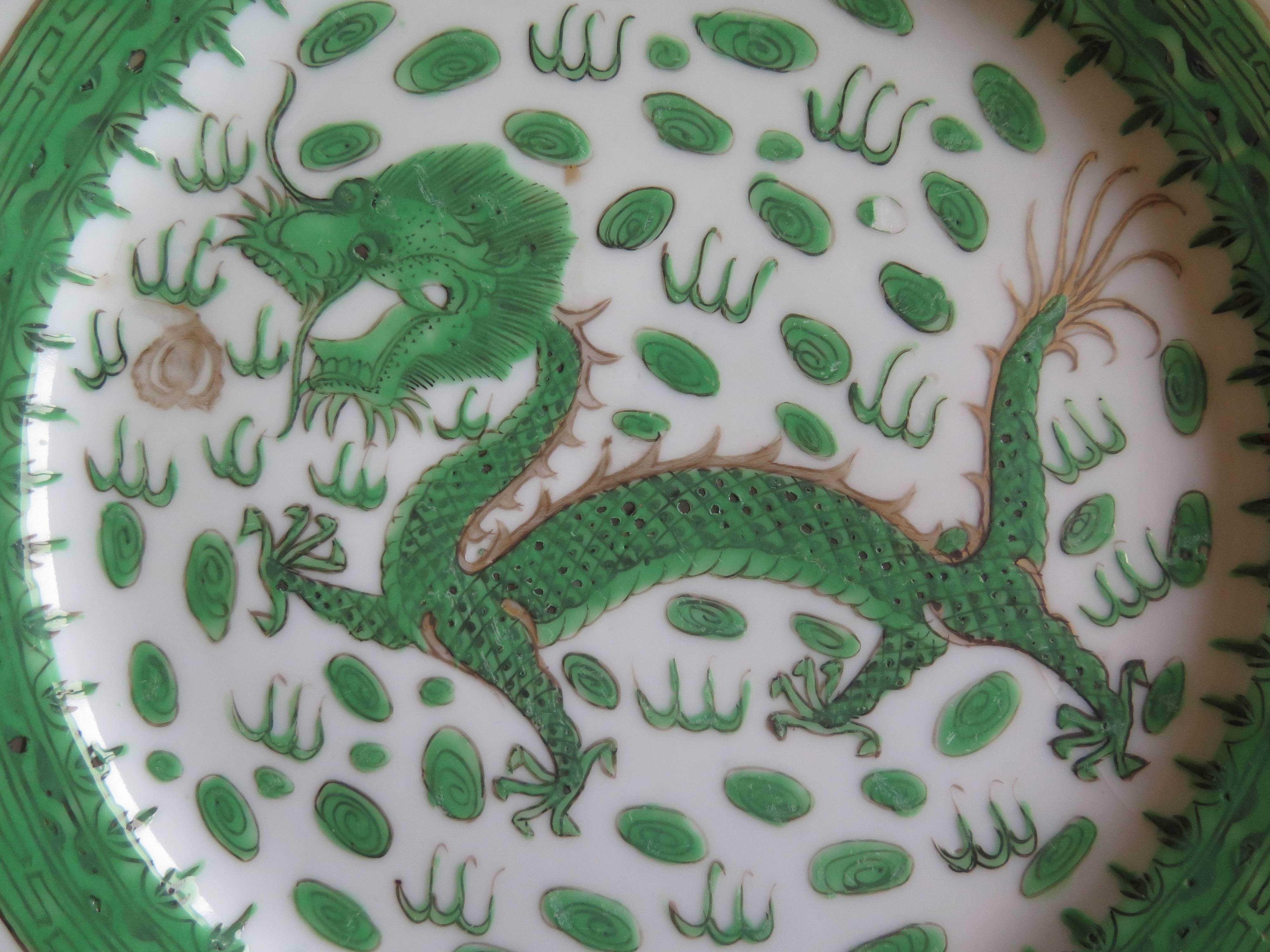 This is a beautiful Chinese porcelain plate from the early 19th century of the Qing dynasty, decorated in the Famille Verte (green) palette.

The circular plate has a fluted shaped rim and is finely potted with a very neatly trimmed foot. 

It