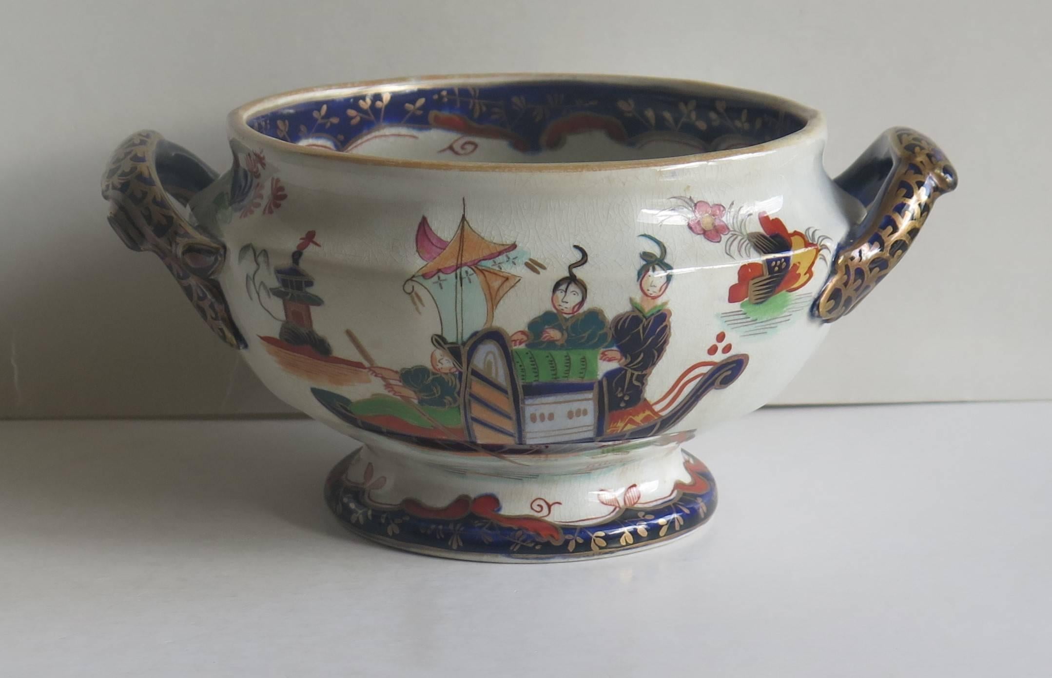 This is a highly decorative, ironstone, twin handled circular footed Bowl by John Ridgway, dating to the English William 1Vth period, circa 1835 .

The bowl has been carefully hand-painted in bold colorful enamels with a chinoiserie pattern of three