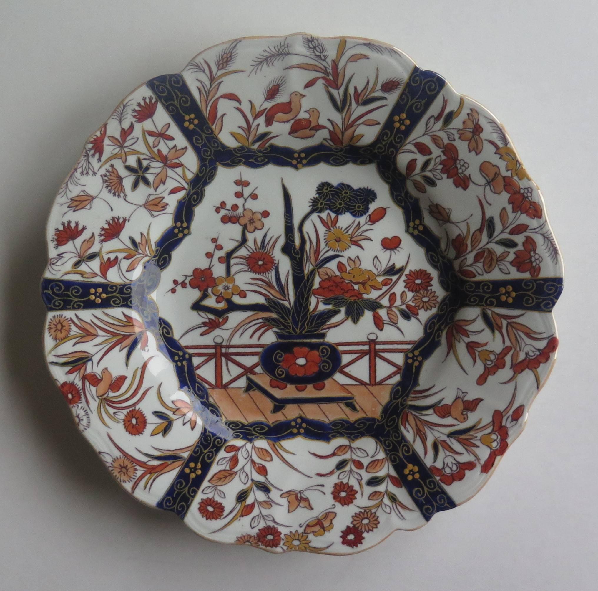This is a very attractive Desert Plate or Dish made by Mason's Patent Ironstone China, dating to the earlier part of the 19th century.

This plate is decorated in the Fence and Bowl pattern, which shows a central flower filled vase, on a low stand