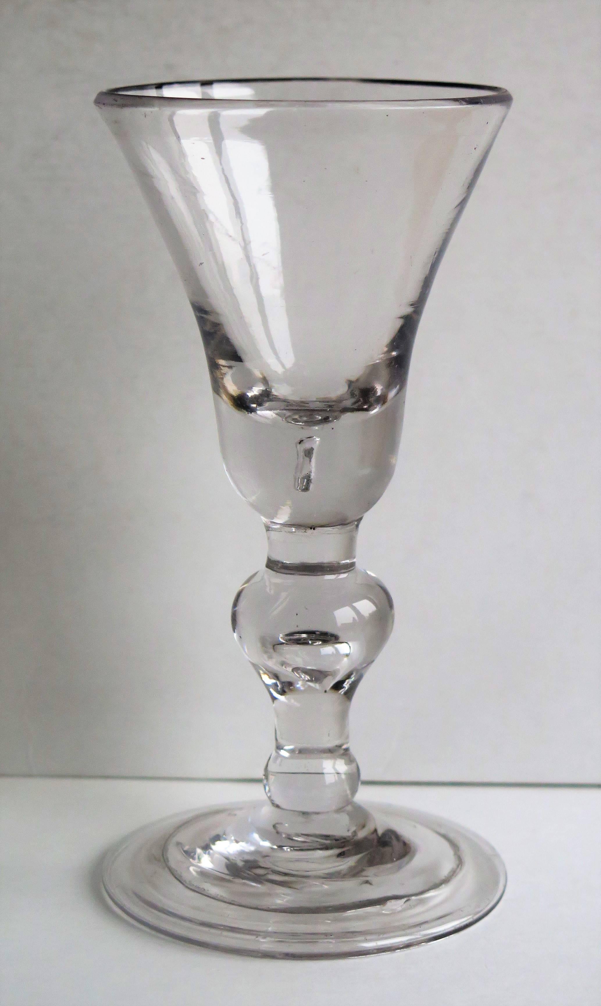 This is a very good English, hand-blown, Heavy Baluster wine drinking glass, dating to the late 17th century to very early in the 18th century, circa 1690-1710 which spans the reigns of William and Mary to William 111 to Queen Anne.

Heavy baluster