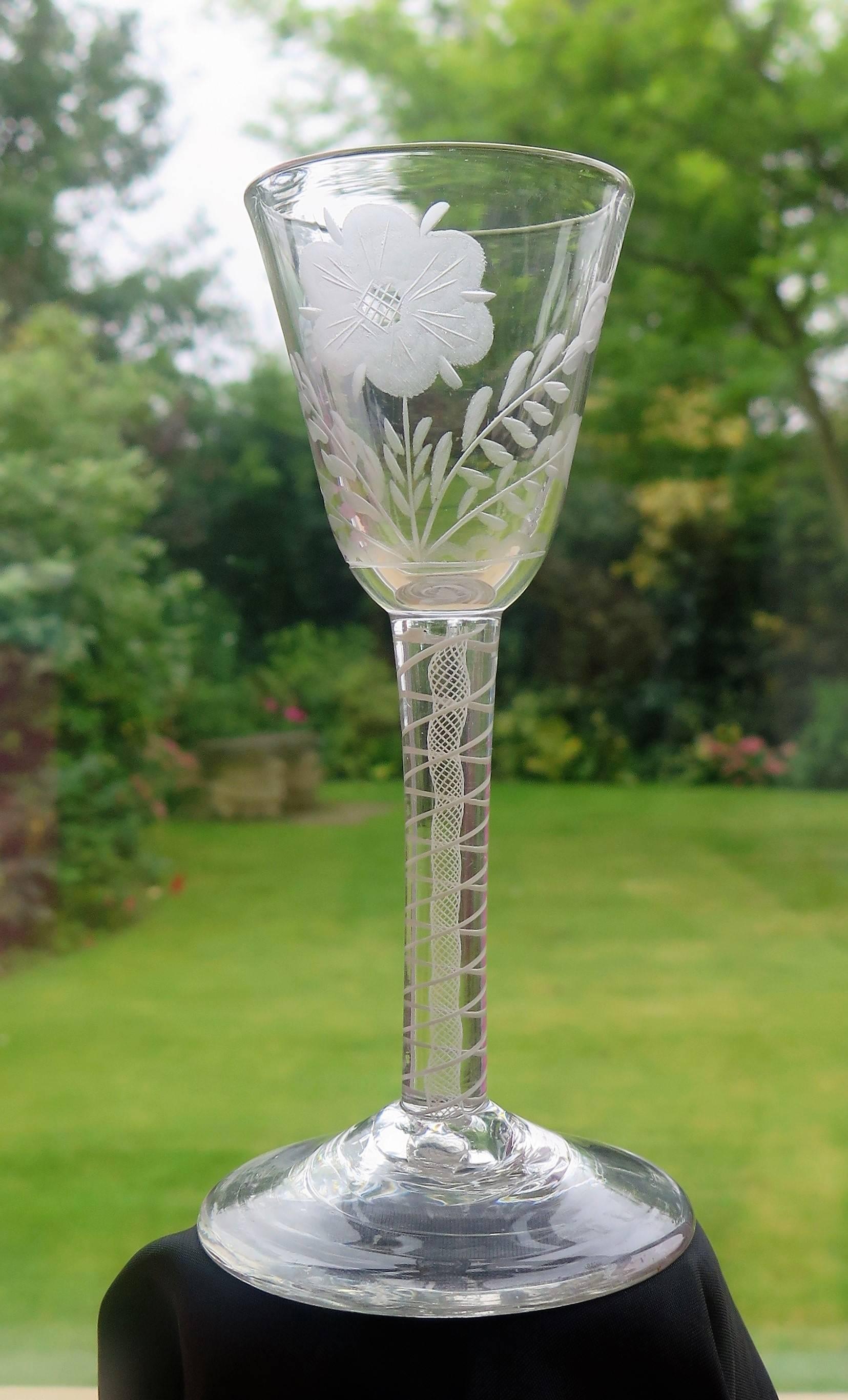 This is a good hand-blown, Jacobite English, mid-Georgian, wine drinking glass with an engraved bowl and an opaque twist stem, dating from the middle of the 18th century, circa 1760.

Jacobite glasses have historical significance and are very