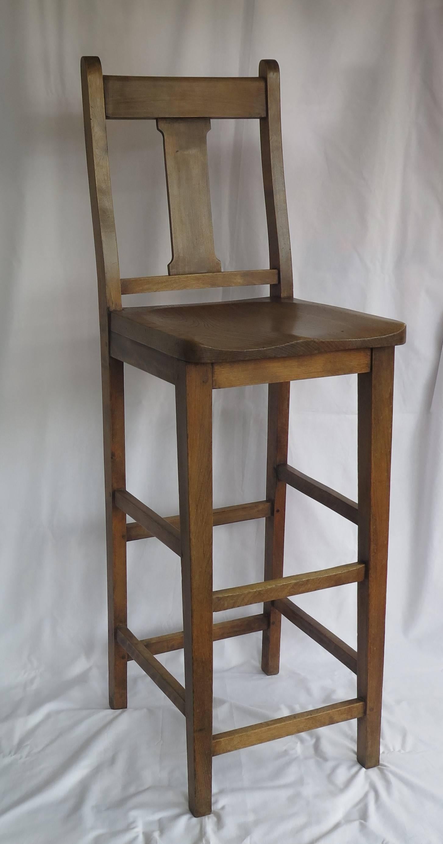 This is a late 19th century Clerk's Estate High Chair as used at a Clerk's Desk in the late Victorian period, circa 1880, now very useful as a kitchen chair at a breakfast bar.

The chair is made of beech with a shaped elm seat and a nicely curved