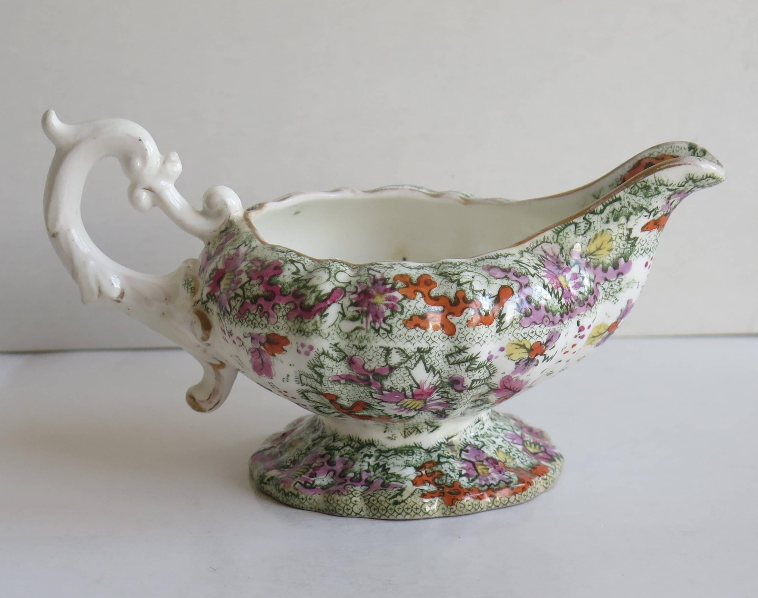 This is a porcelain cream or milk jug, produced by Mason's (C J ) at the Lane Delph, Staffordshire Potteries, England, circa 1832-1836.

The jug is footed and vertically fluted with a good rococo loop handle, having an upper and lower spur.

The