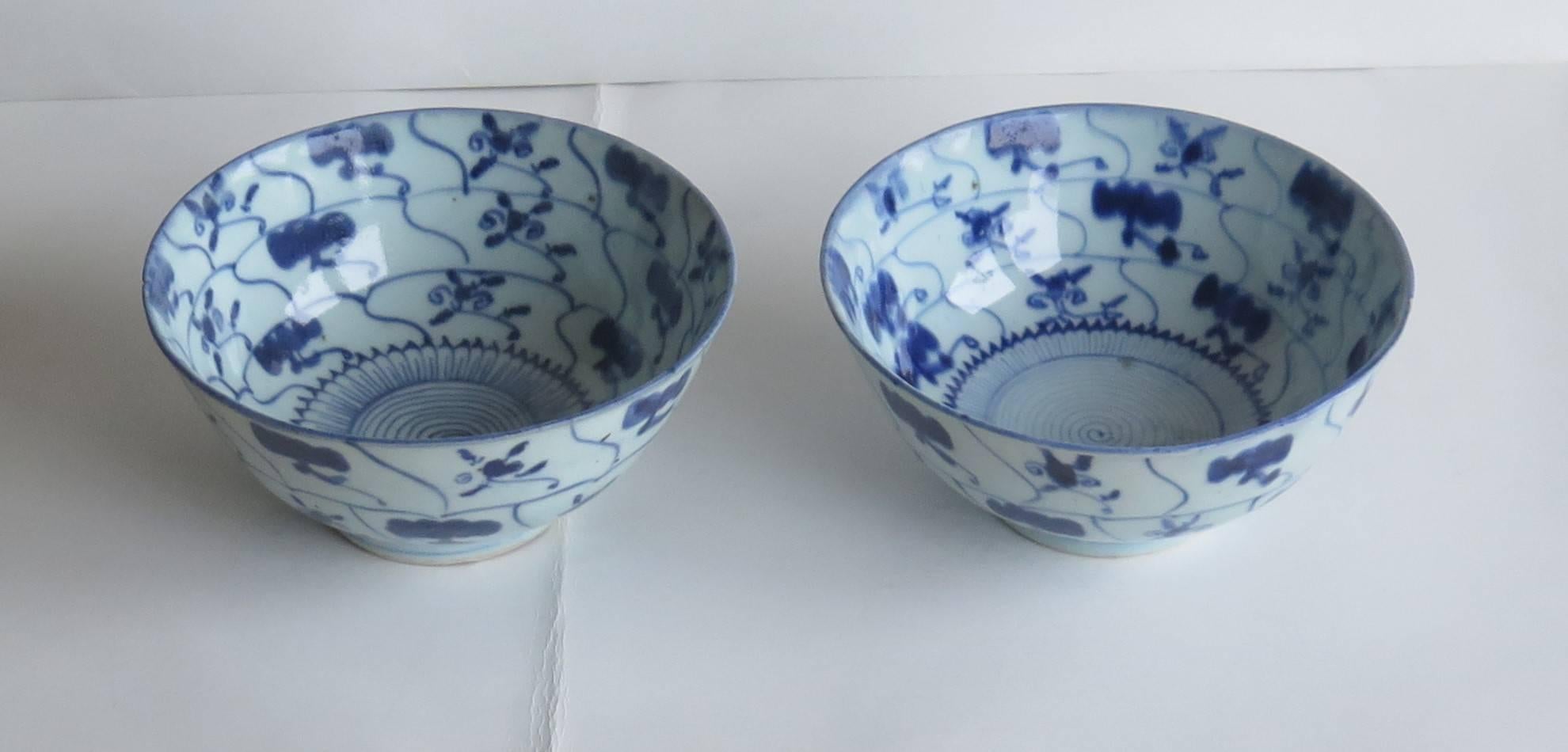 These are a beautiful pair of circular Chinese porcelain, blue and white bowls, which we date to the 18th century, circa 1770. 

Both bowls have a very good ring to them when tapped with a finger.

Both bowls are of a lotus form and are hand painted