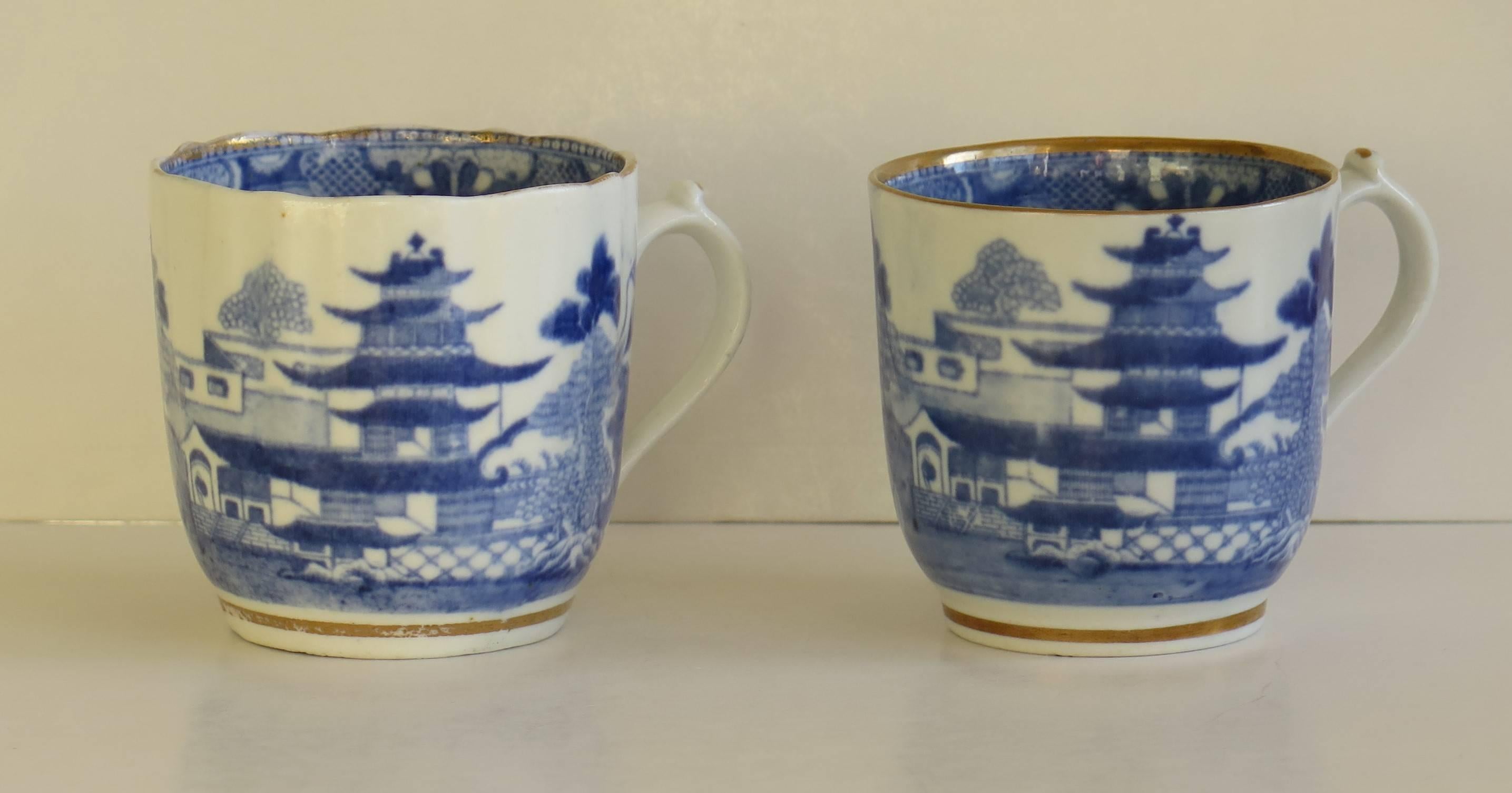 Both of these porcelain coffee cans were made by Miles Mason (Mason's), Staffordshire potteries, England around the turn of the 18th century. 

They are very similar, both of a butte shape on a small foot with loop handles having the distinctive